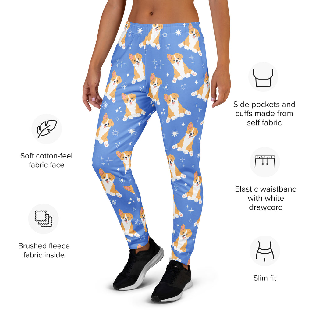 Women’s blue recycled jogger pants with orange and white corgi dog pattern and star accents featuring cozy brushed fleece