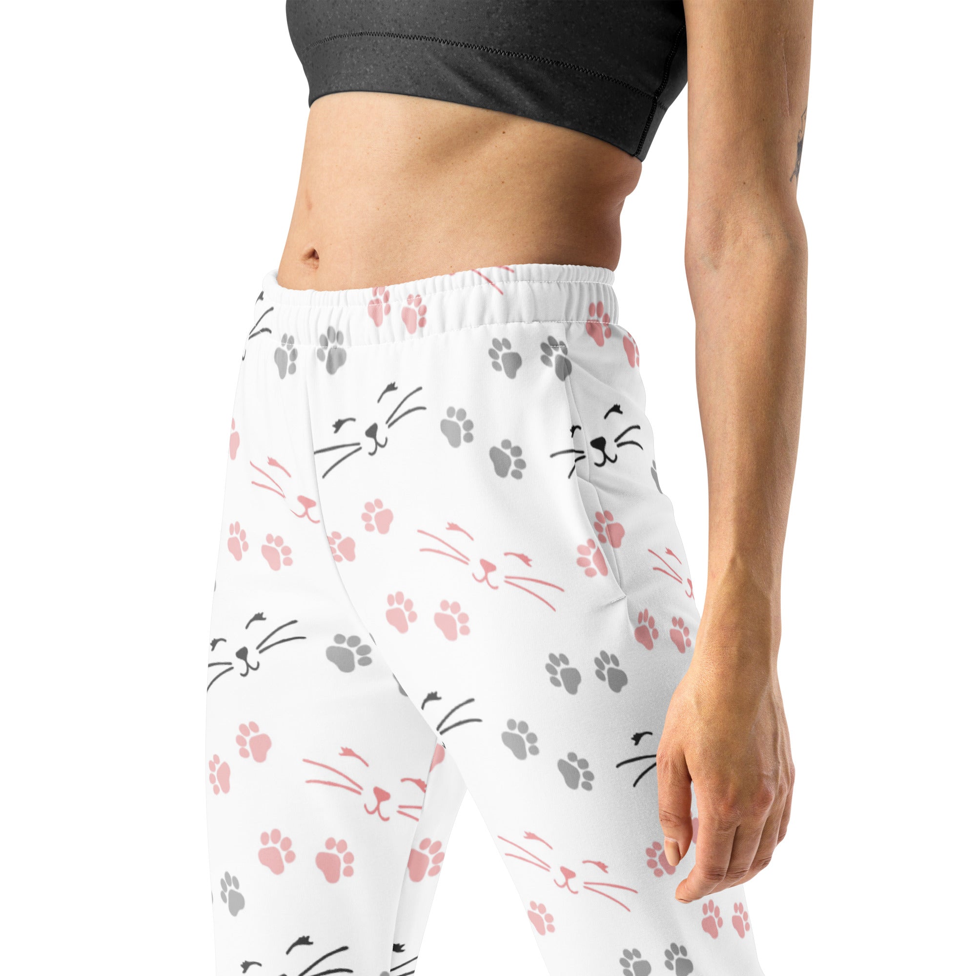 White leggings with pink and gray cat faces and paw prints made from cozy recycled fleece with pockets