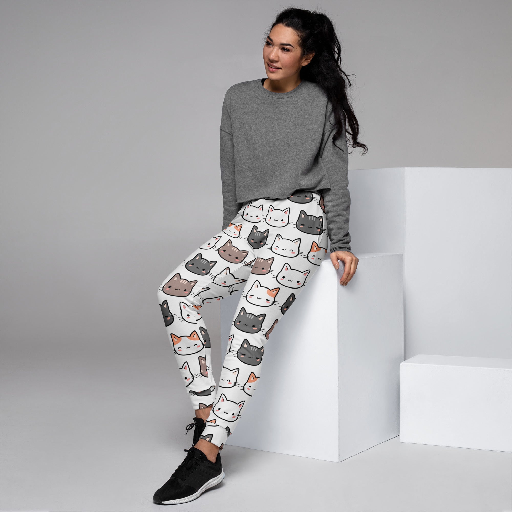 White women’s cat recycled jogger pants with pockets featuring colorful cartoon cats and cozy brushed fleece inside