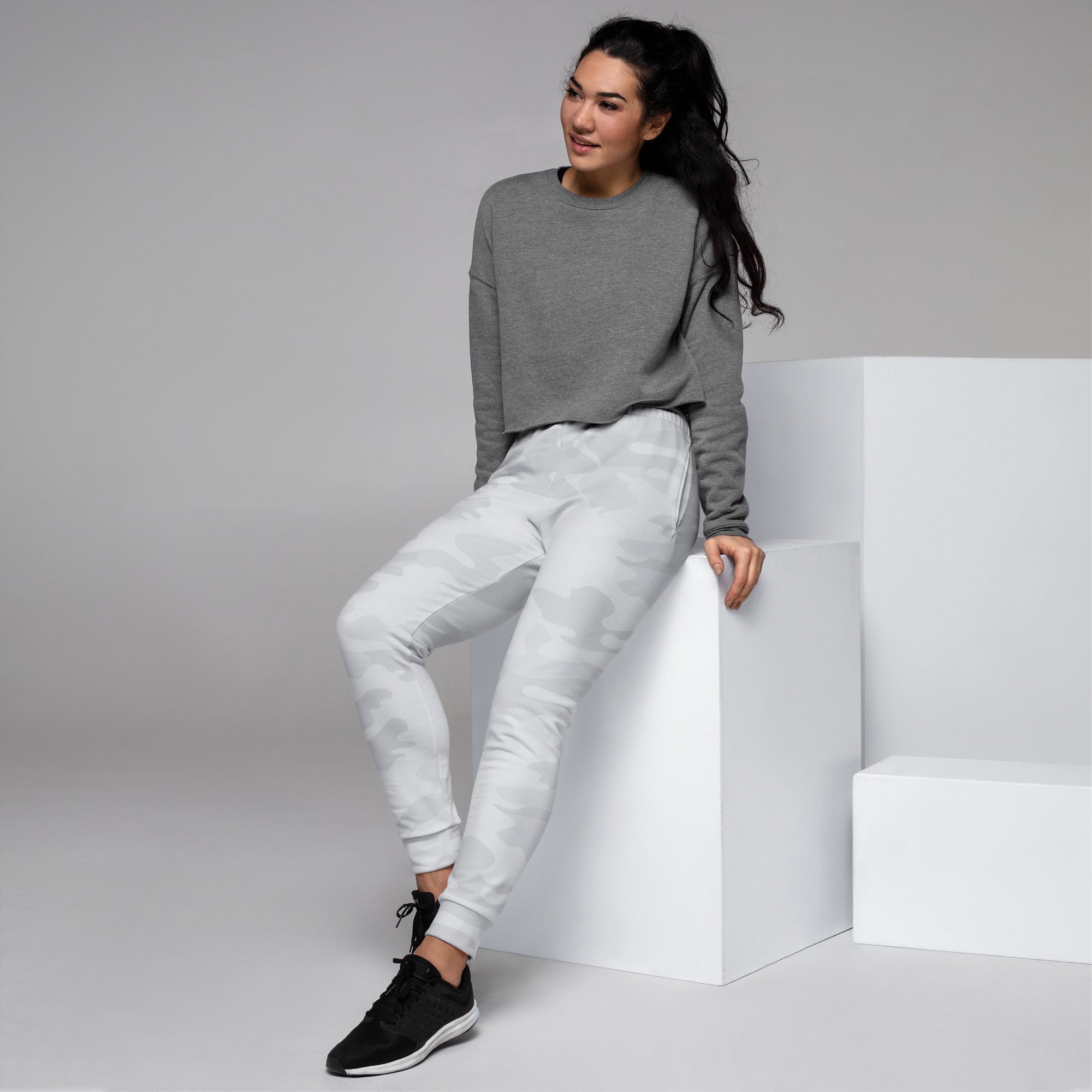 Women’s gray heathered sweatshirt with long sleeves and relaxed fit paired with recycled camouflage jogger pants with pockets