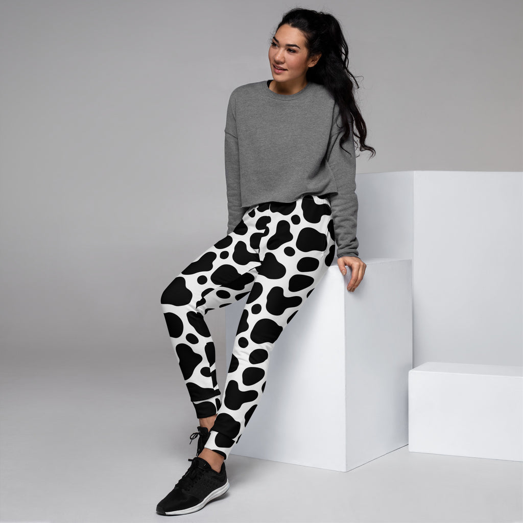 Women’s black and white cow print recycled jogger pants with pockets cozy brushed inside fleece material