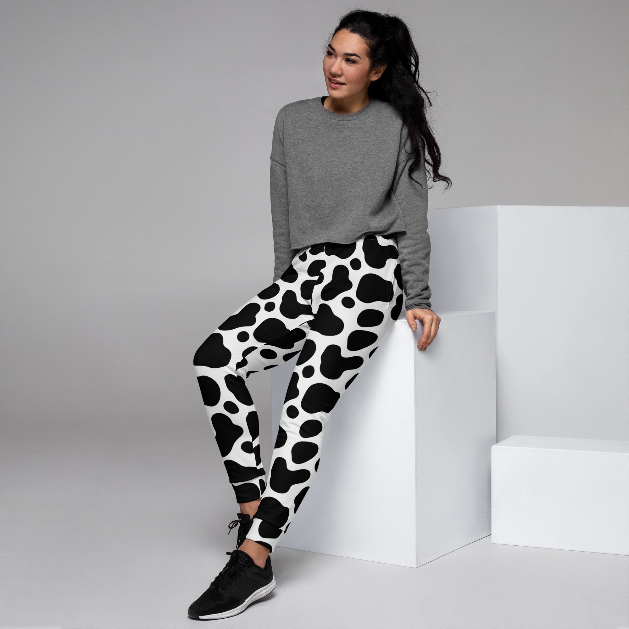 Women’s black and white cow print recycled jogger pants with pockets cozy brushed inside fleece material