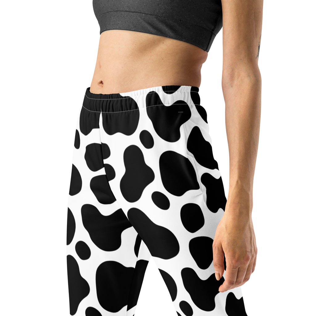 Women’s black and white cow print recycled jogger pants with pockets and cozy brushed inside fleece lining