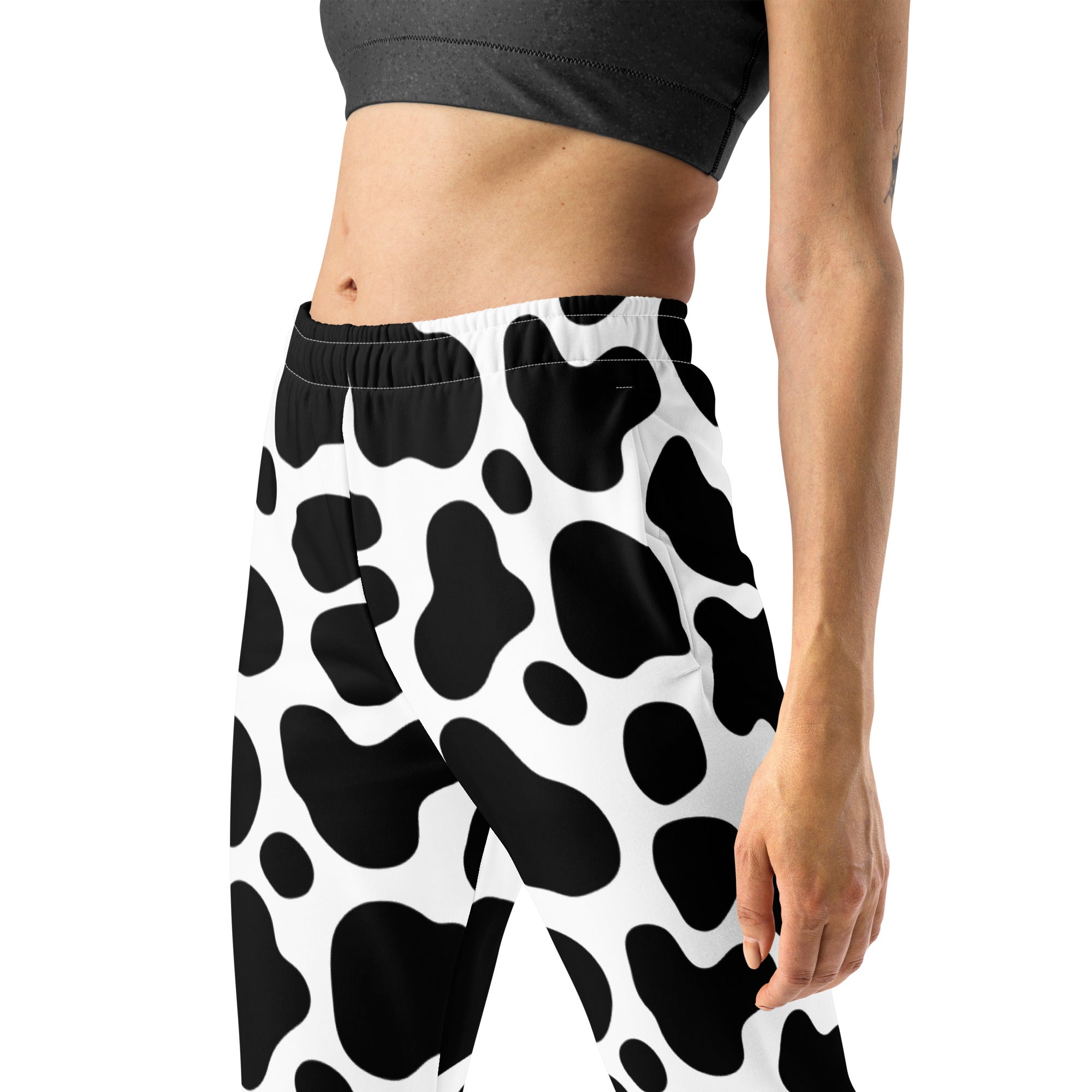 Women’s black and white cow print recycled jogger pants with pockets and cozy brushed inside fleece lining