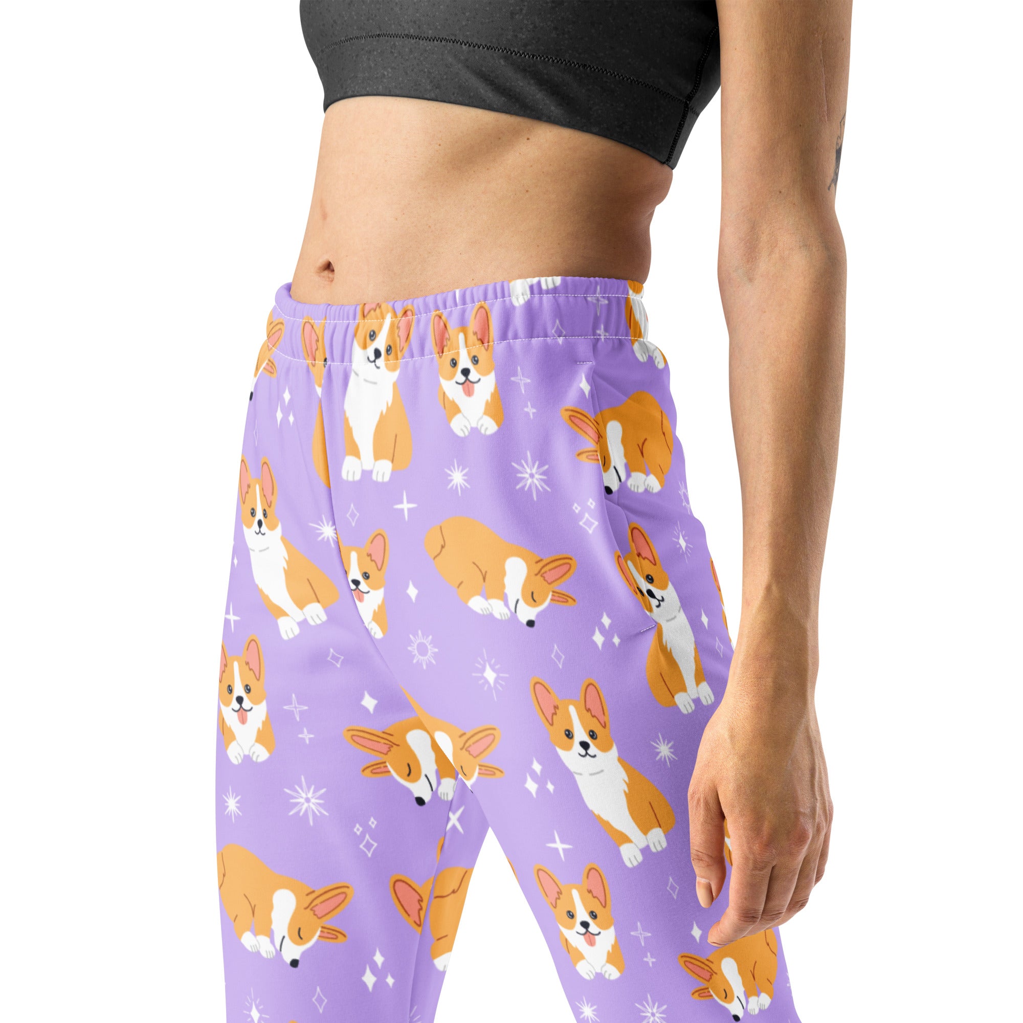 Women’s purple recycled jogger pants with cozy fleece inside featuring orange white corgi dog pattern and star accents