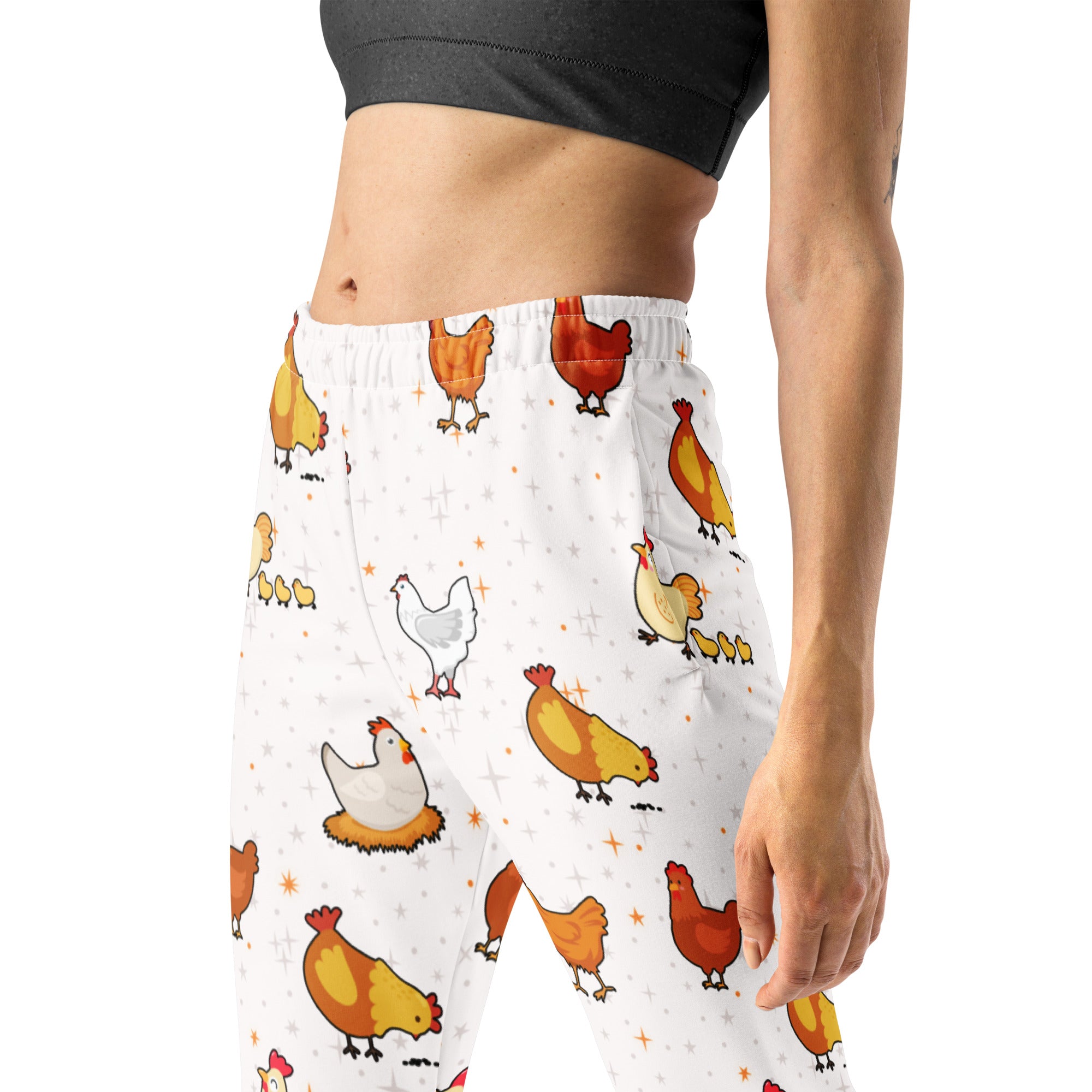 Women’s white recycled jogger pants with cozy brushed fleece inside featuring colorful cartoon chicken and star patterns