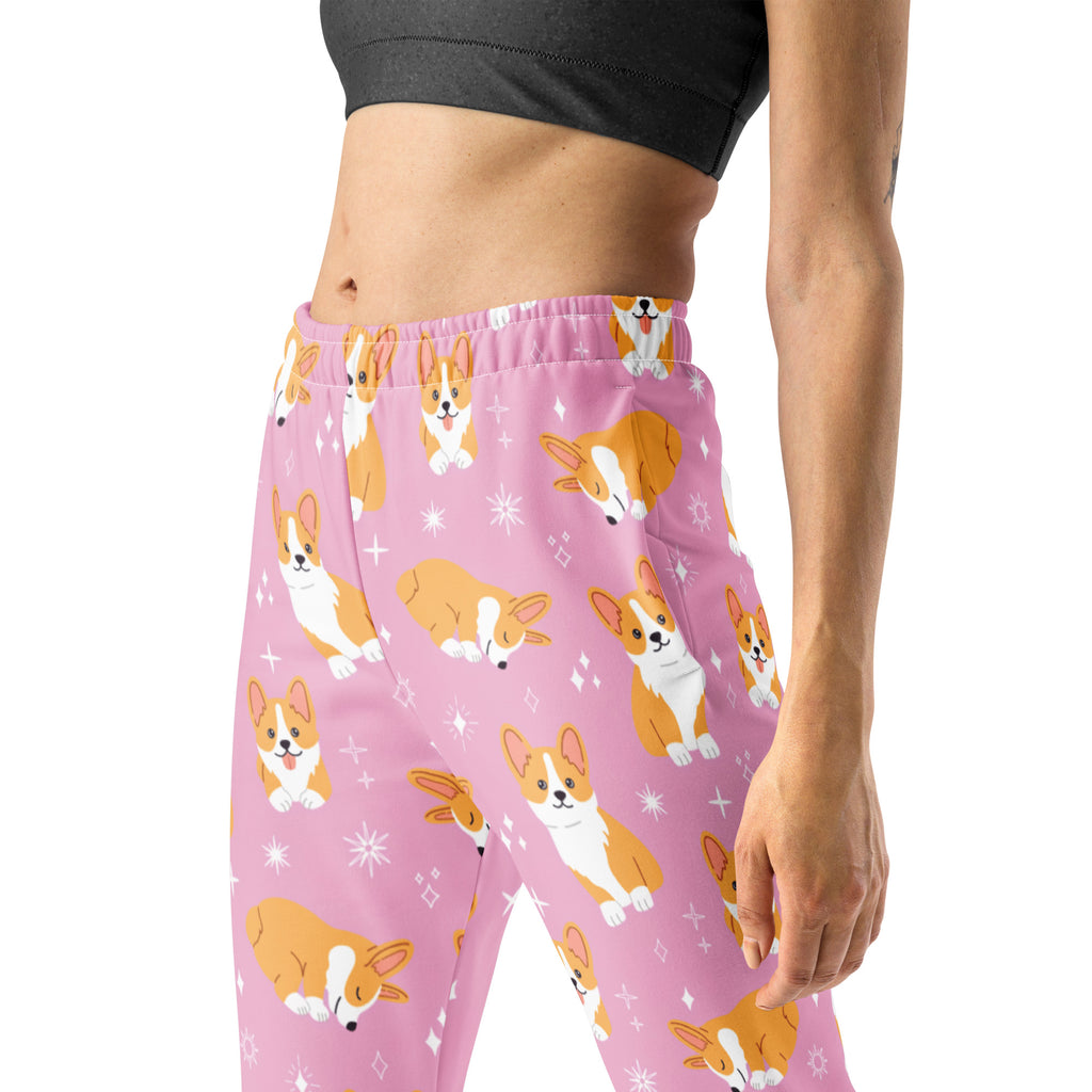 Women’s pink jogger pants with pockets featuring orange and white corgi pattern and cozy brushed inside fleece