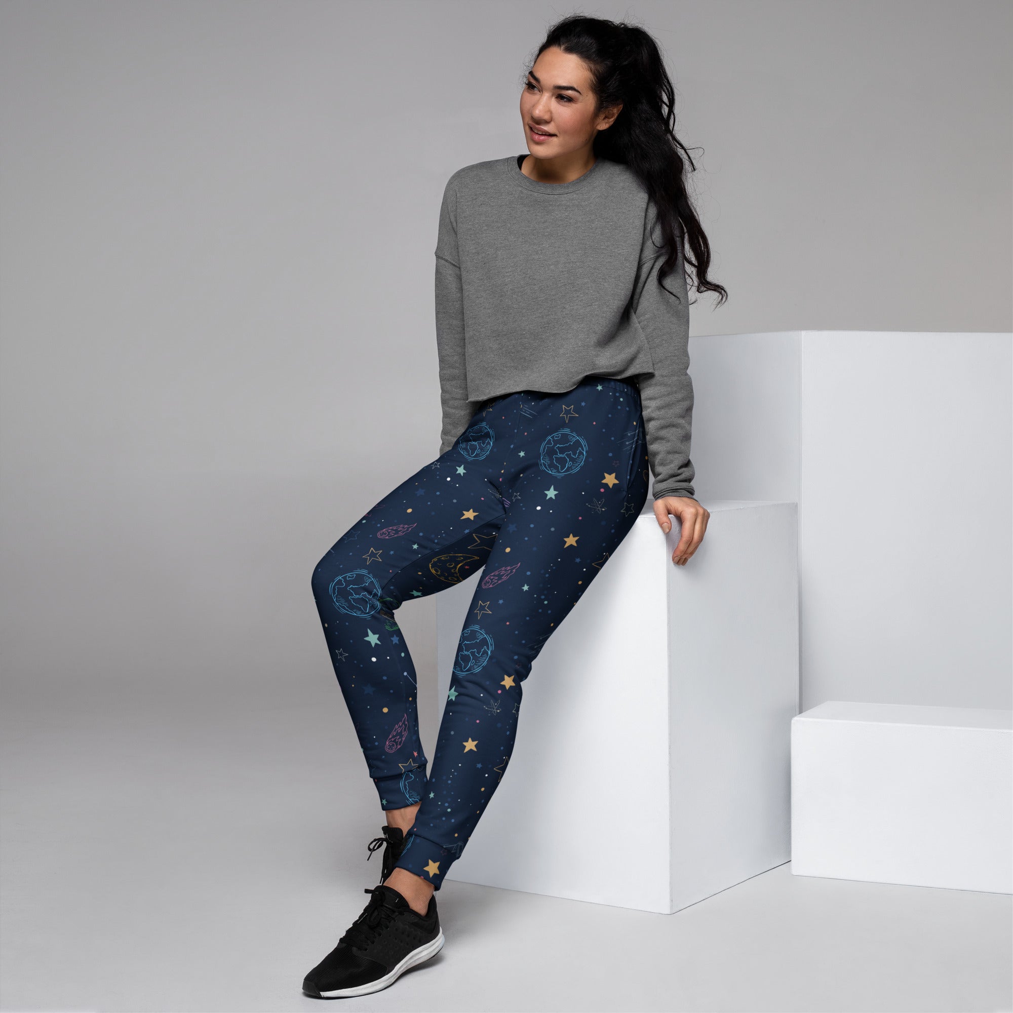 Women’s dark blue space-themed recycled jogger pants with metallic gold celestial patterns and cozy fleece lining
