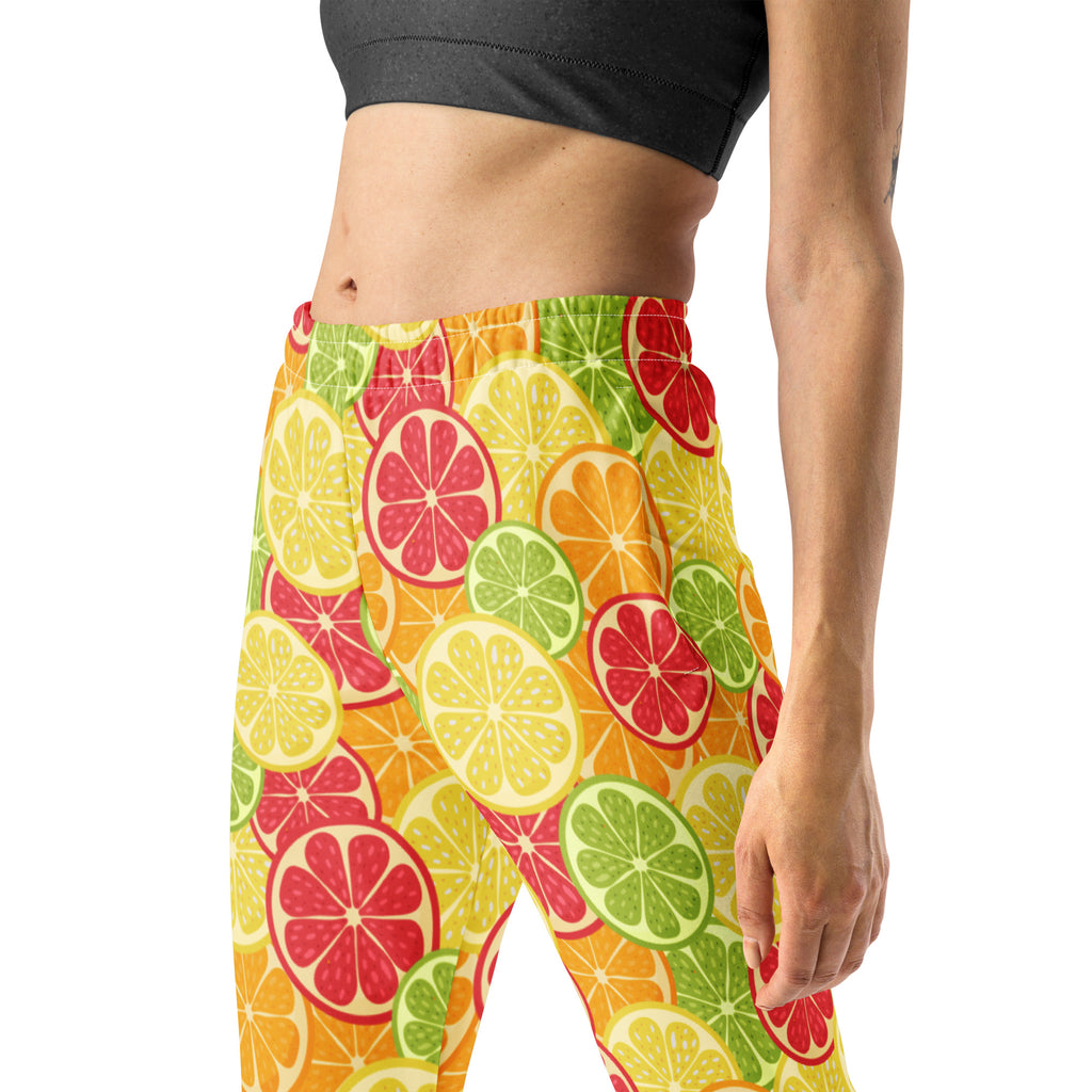 Women’s citrus slice recycled jogger pants with pockets featuring vibrant citrus fruit pattern and cozy brushed fleece lining