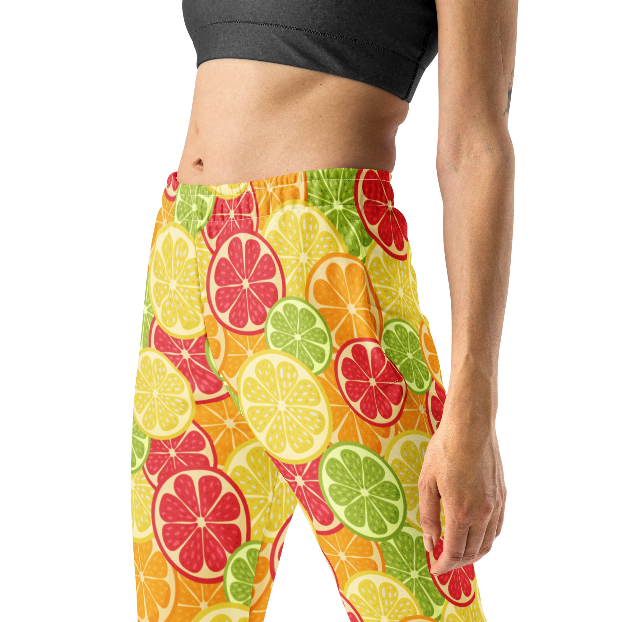 Women’s citrus slice recycled jogger pants with pockets featuring vibrant citrus fruit pattern and cozy brushed fleece lining