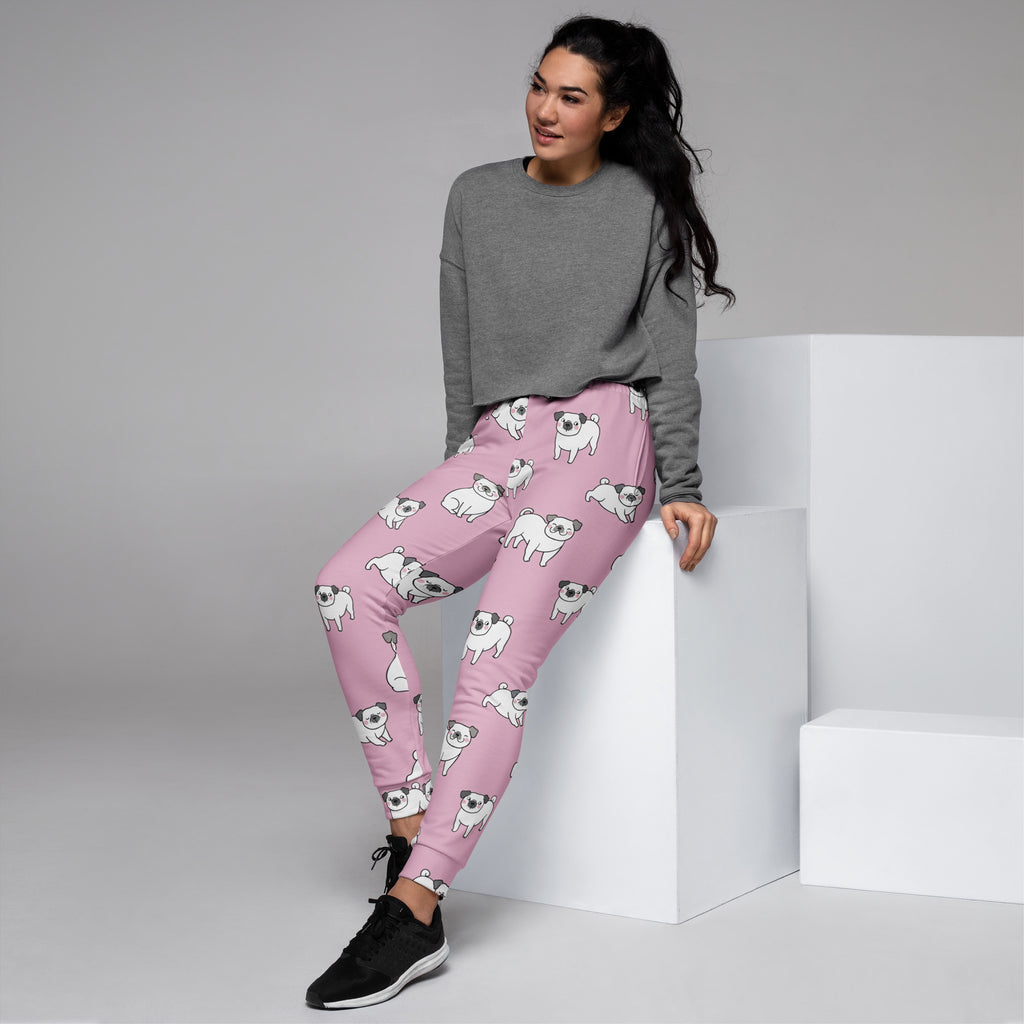 Women’s pink recycled jogger pants with pockets featuring white pug illustrations and cozy brushed fleece inside