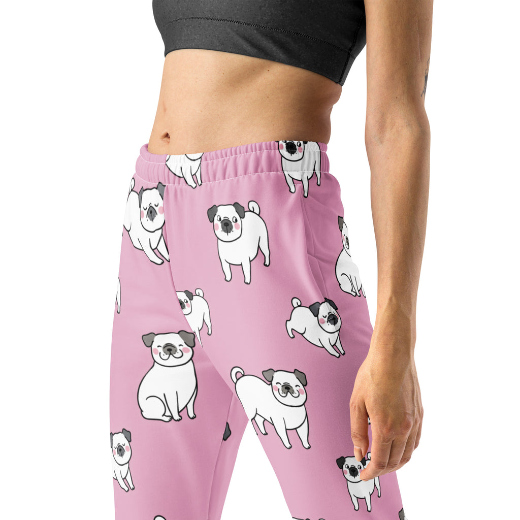 Women’s pink recycled jogger pants with pockets featuring a playful white pug pattern and cozy brushed fleece inside