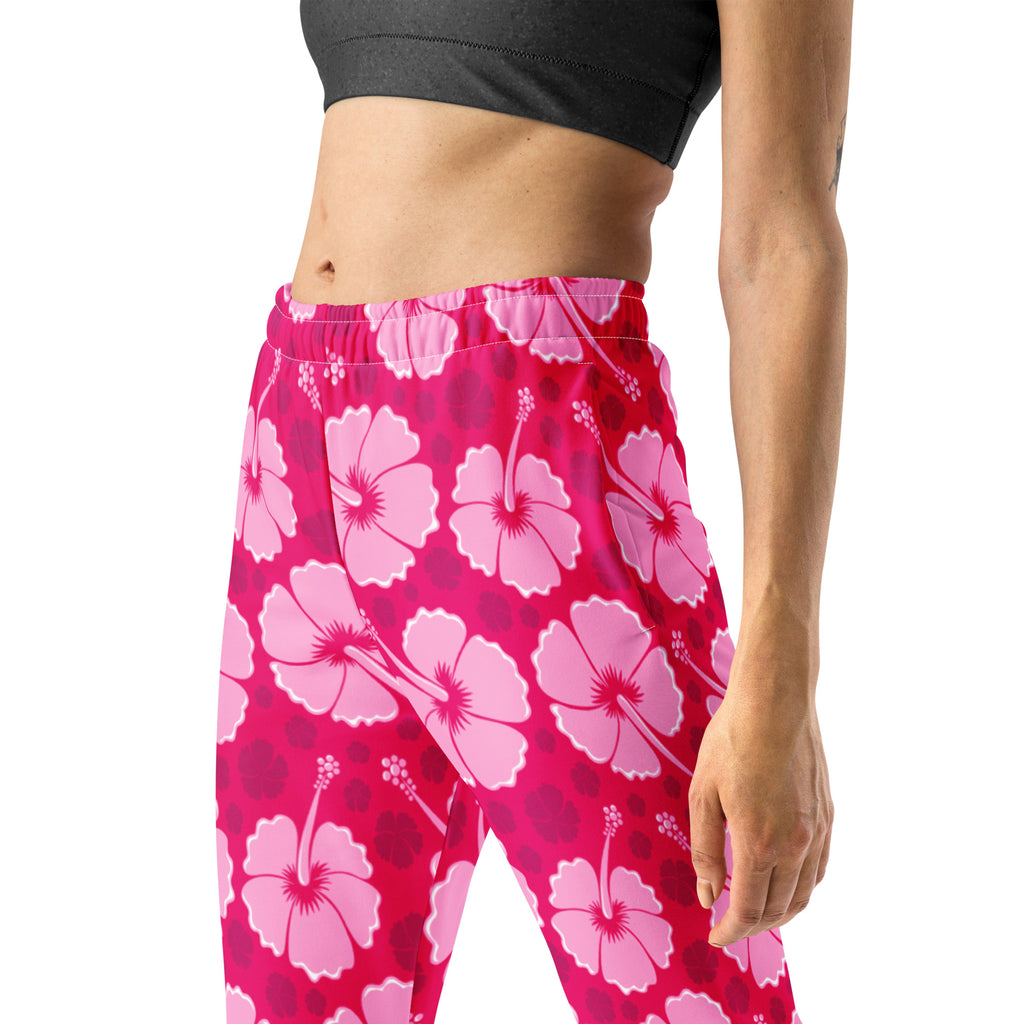 Women’s pink hibiscus floral recycled jogger pants with pockets featuring a vibrant magenta background and fleece lining