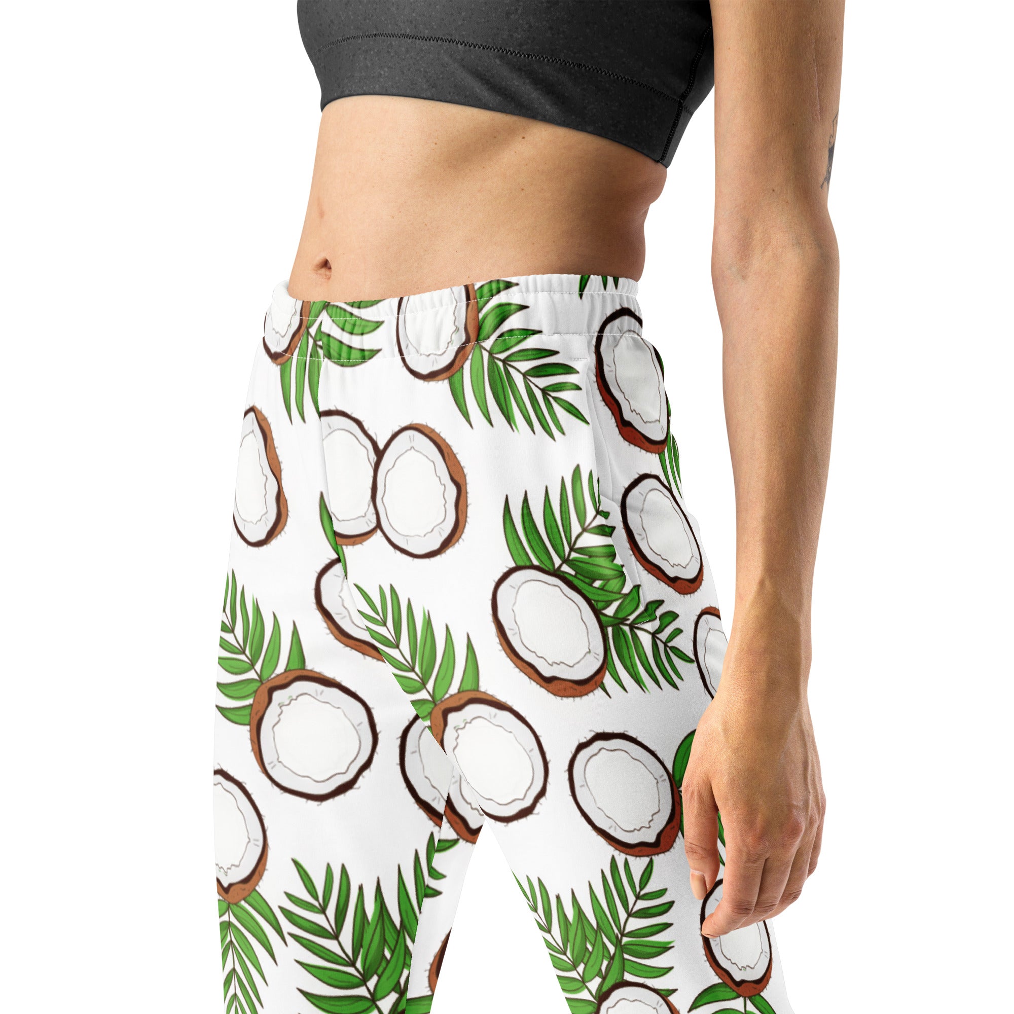 White recycled jogger pants with pockets featuring vibrant coconut slices and green palm leaves and cozy fleece lining