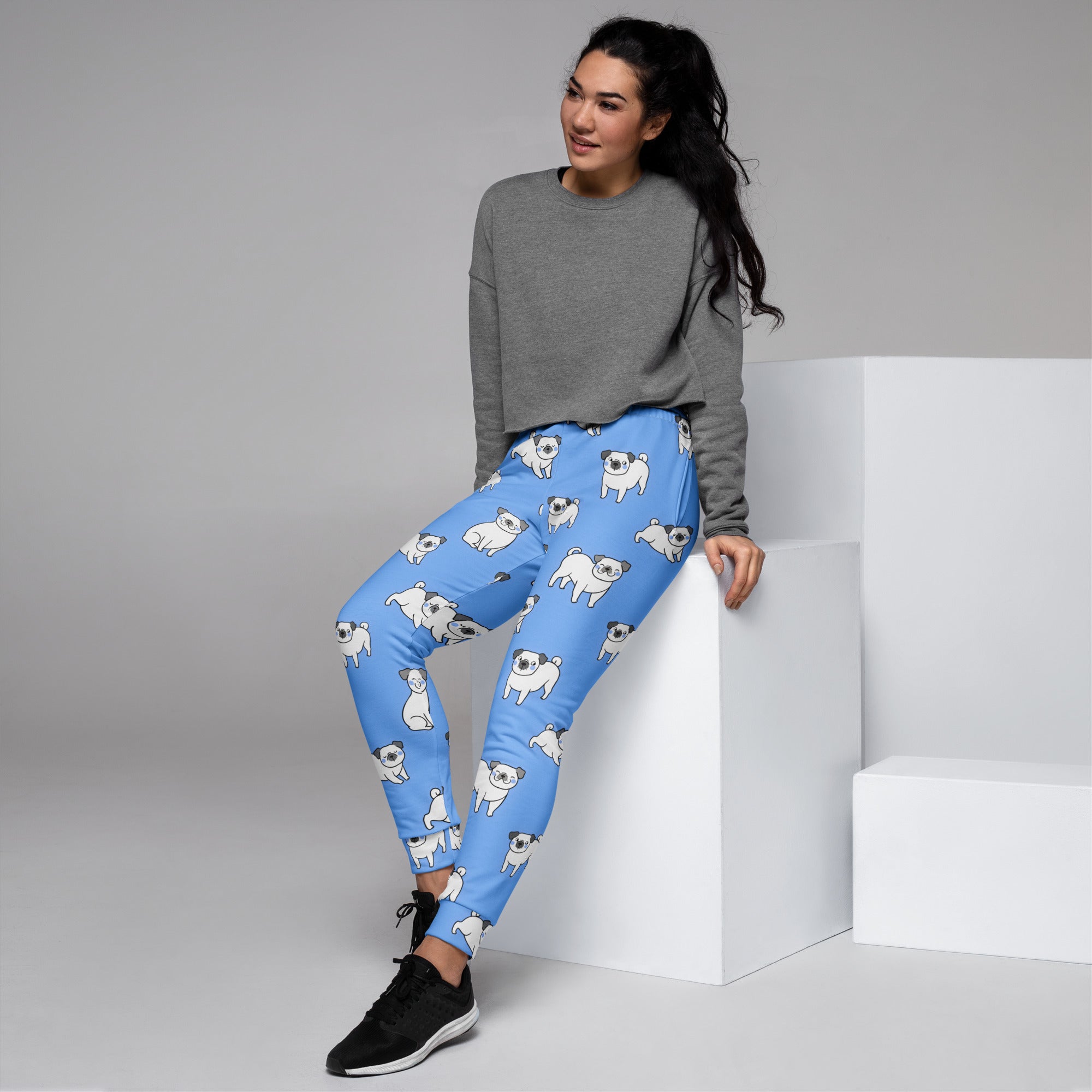 Women’s blue jogger pants with white pug pattern made from recycled fabric cozy brushed fleece inside