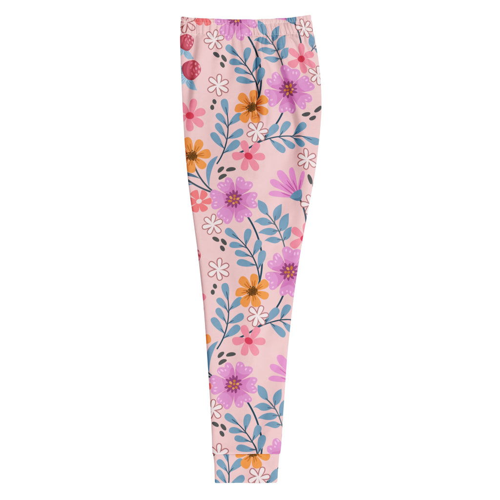 Women’s pink floral recycled jogger pants with pockets featuring purple orange flowers and blue leaves on blush fleece