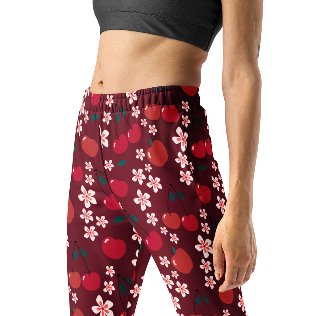 Women’s maroon cherry blossom recycled jogger pants with pockets featuring red cherries and pink blossoms and cozy fleece lining