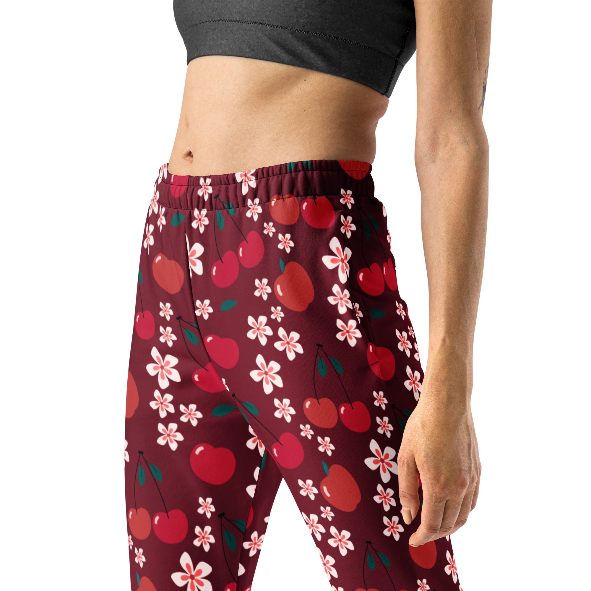 Women’s maroon cherry blossom recycled jogger pants with pockets featuring red cherries and pink blossoms and cozy fleece lining