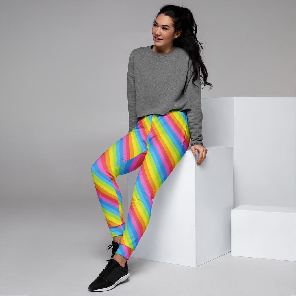 Women’s rainbow stripe recycled jogger pants with cozy brushed fleece inside and vibrant diagonal pink yellow blue green stripes