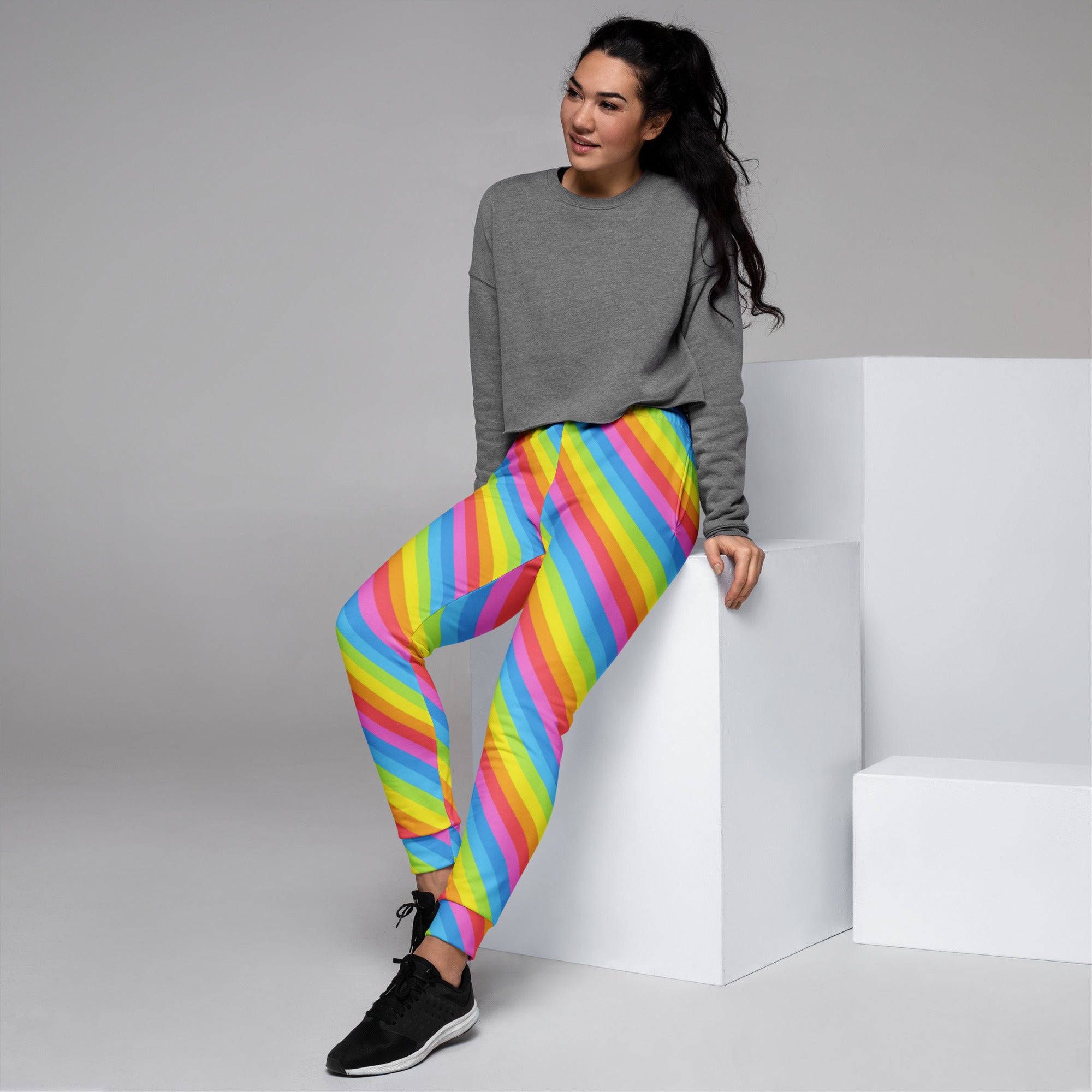 Women’s rainbow stripe recycled jogger pants with cozy brushed fleece inside and vibrant diagonal pink yellow blue green stripes