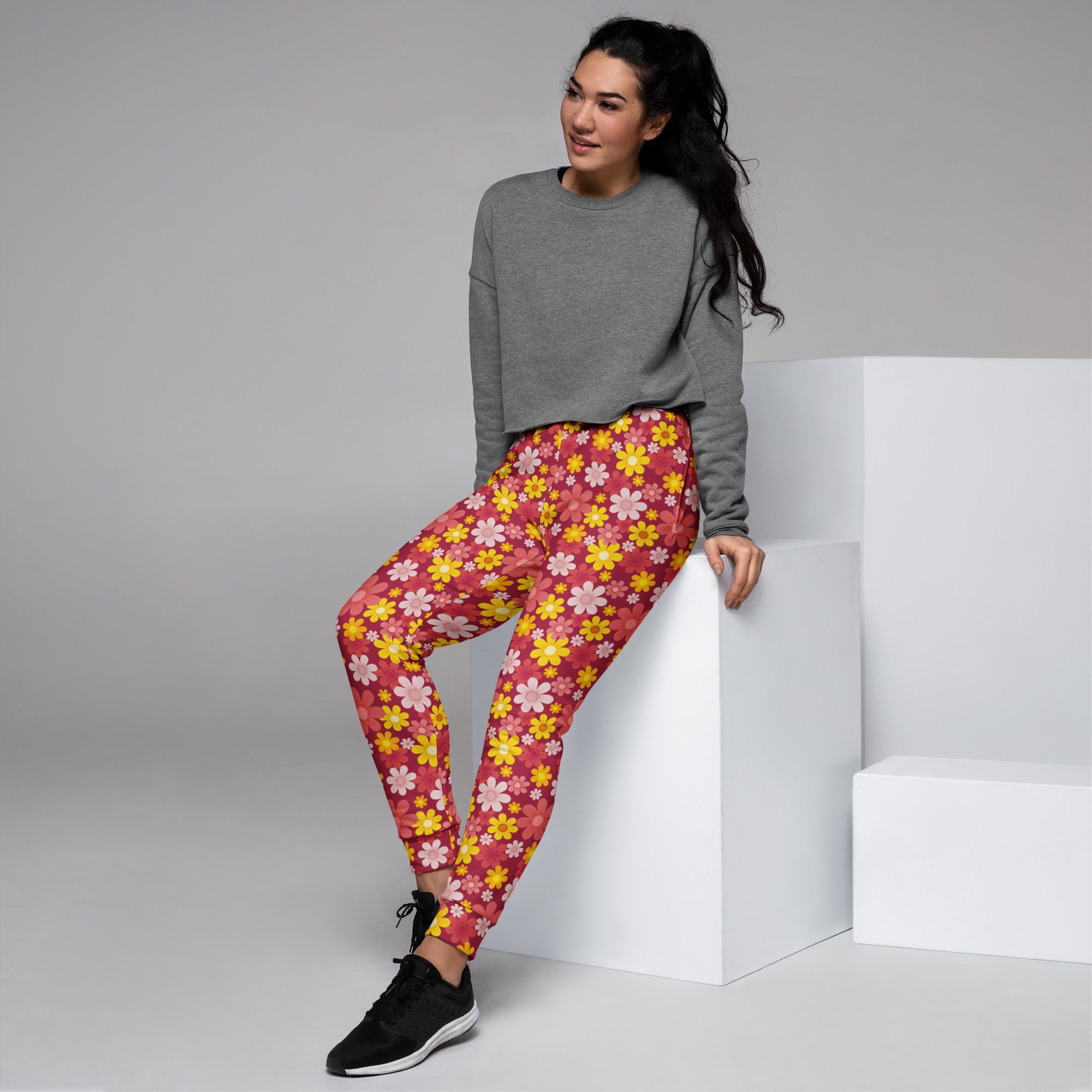 Women’s red floral recycled jogger pants with pockets featuring soft stretchy pink and yellow floral patterned fabric