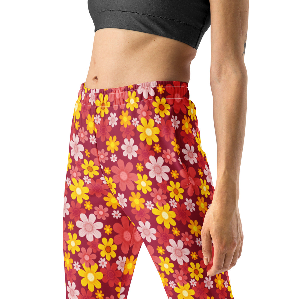 Women’s red floral recycled jogger pants with pockets and cozy brushed fleece inside featuring vibrant leggings print