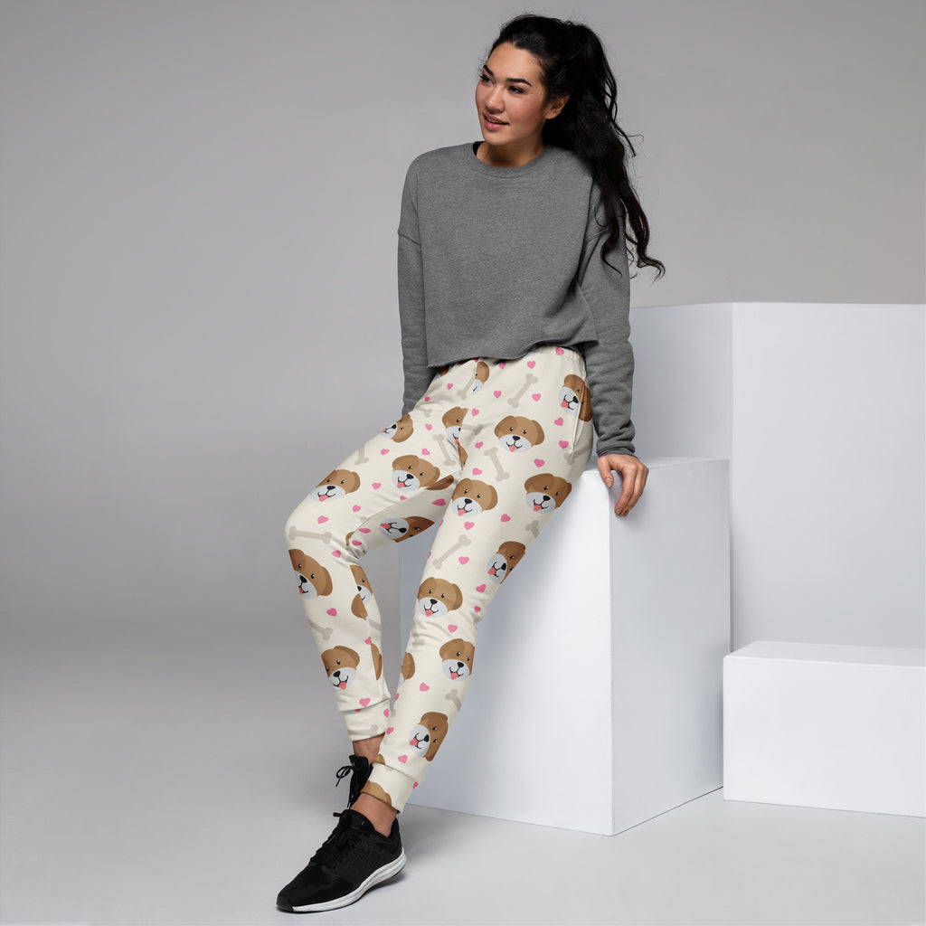 Cream-colored women’s recycled jogger pants with brown puppy faces pink hearts cozy brushed fleece lining and pockets