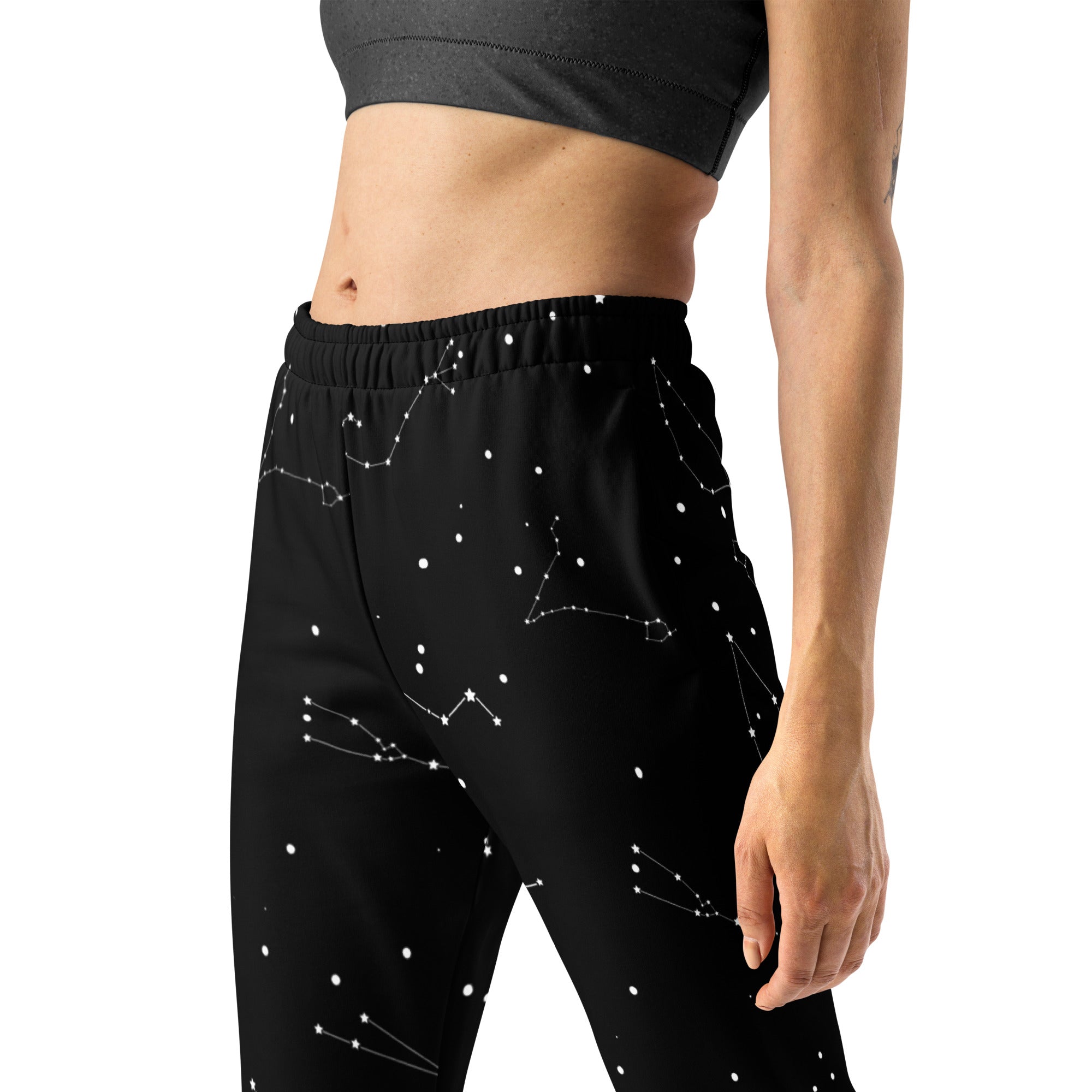 Black women’s jogger pants with white constellation pattern cozy brushed fleece inside made from recycled material