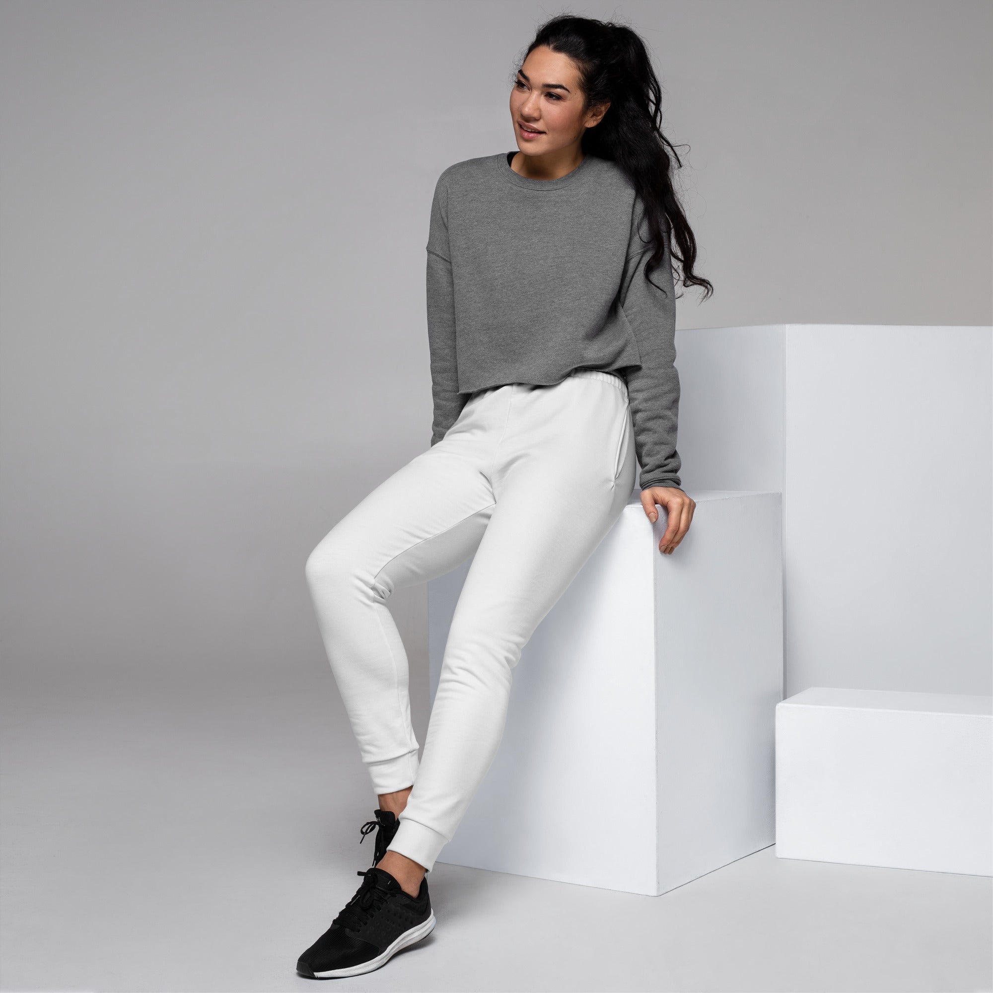 Women’s white recycled jogger pants with pockets featuring a relaxed fit ribbed cuffs and cozy brushed fleece inside