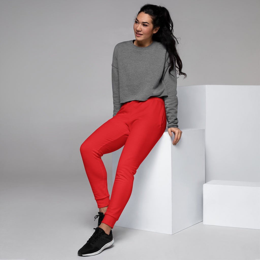Vibrant red women’s recycled jogger pants with snug fit elastic cuffs and cozy brushed inside fleece lining