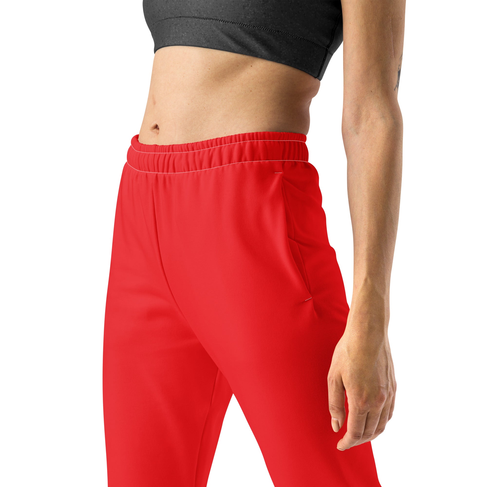 Women’s bright red recycled jogger pants with soft brushed fleece inside an elastic waistband and side pockets