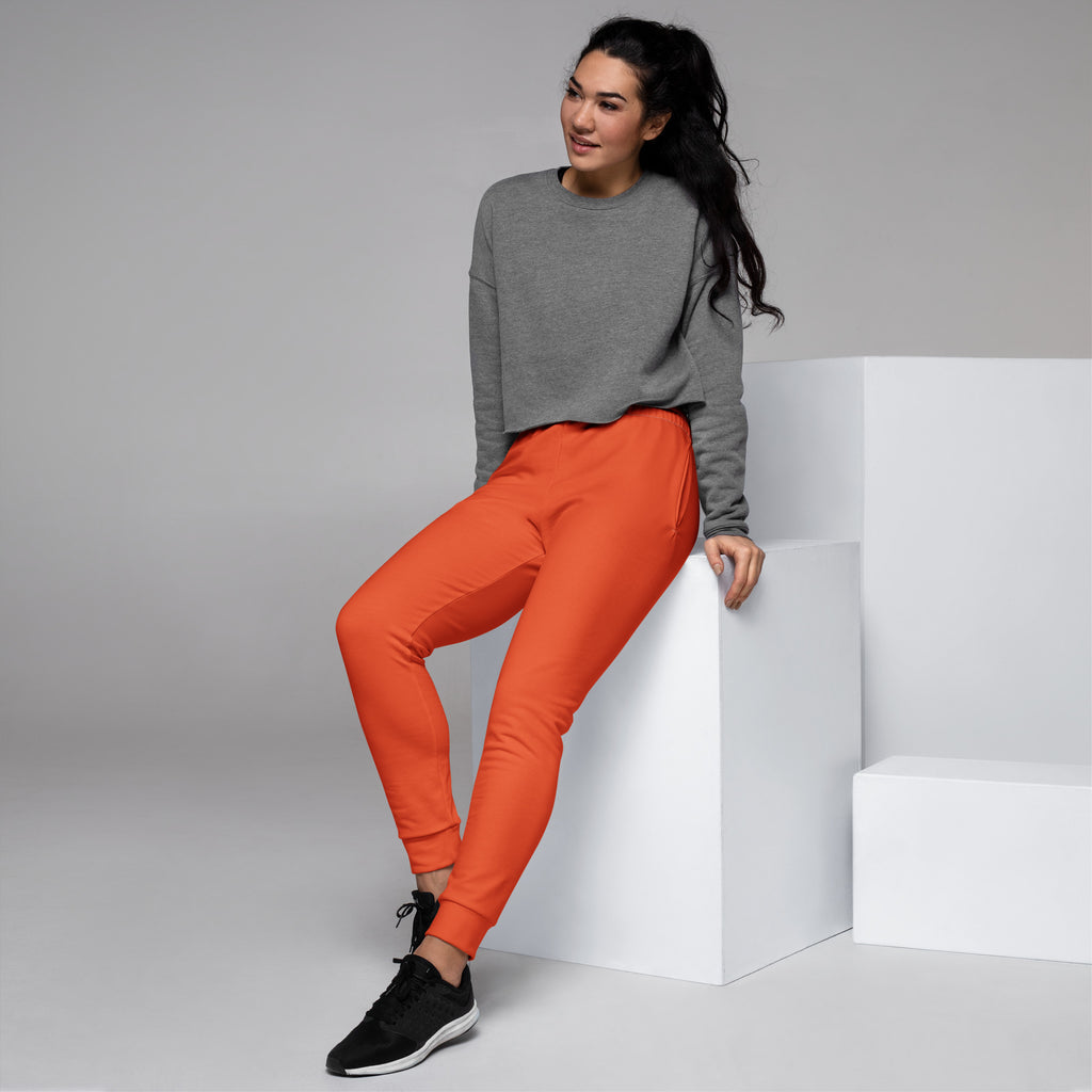 Women’s orange recycled jogger pants with tapered legs ribbed cuffs cozy brushed inside fleece and pockets