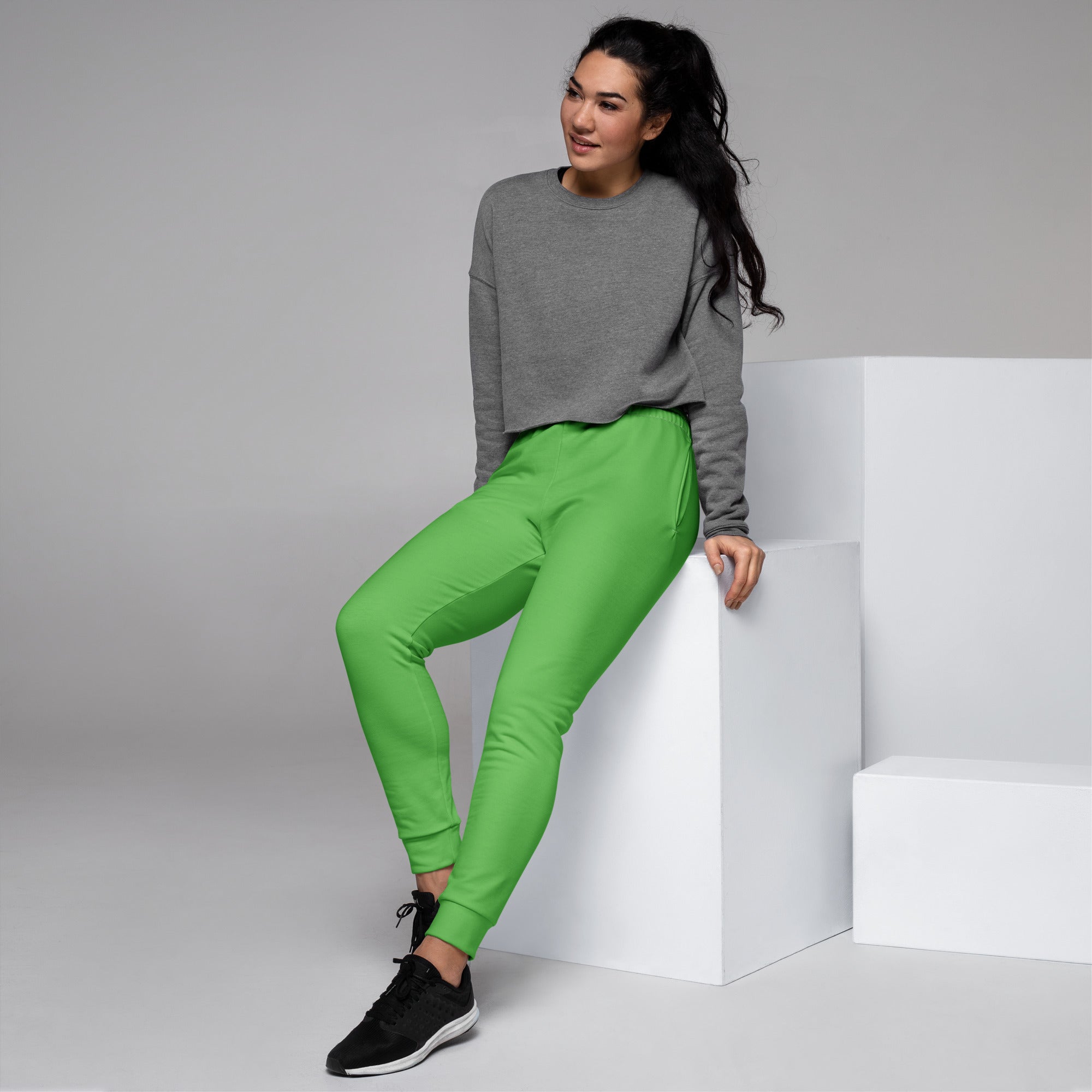 Women’s bright green recycled jogger pants with relaxed fit ribbed cuffs and cozy brushed inside fleece pockets