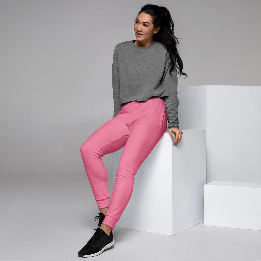 Women’s pink recycled jogger pants with pockets featuring relaxed fit ribbed cuffs and cozy brushed inside fleece
