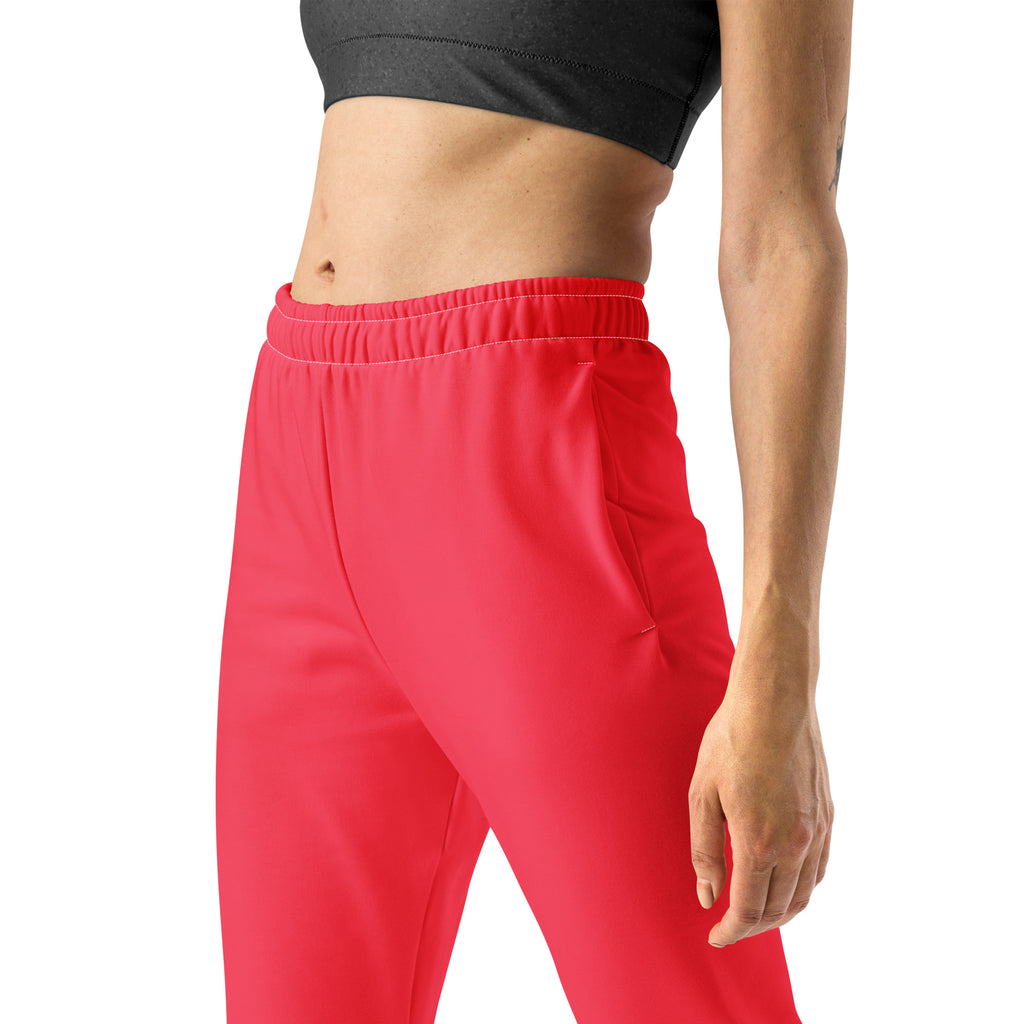 Bright pink women’s recycled jogger pants with elastic waistband side pockets and cozy brushed fleece inside
