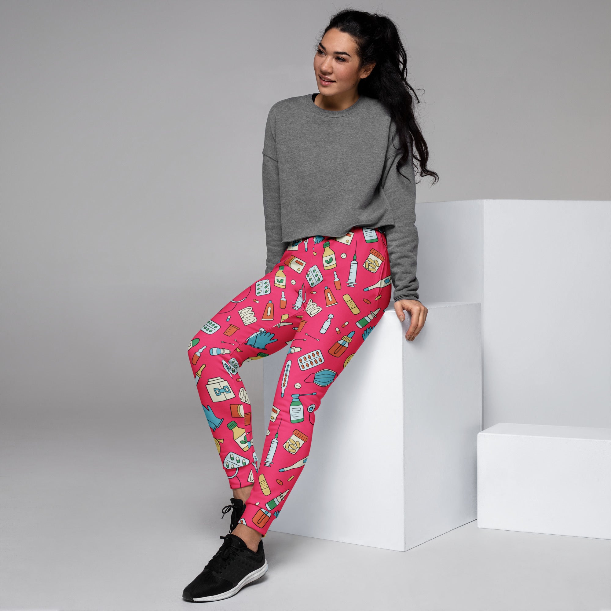 Women’s bright pink recycled jogger pants with playful medical print and cozy brushed inside fleece with pockets