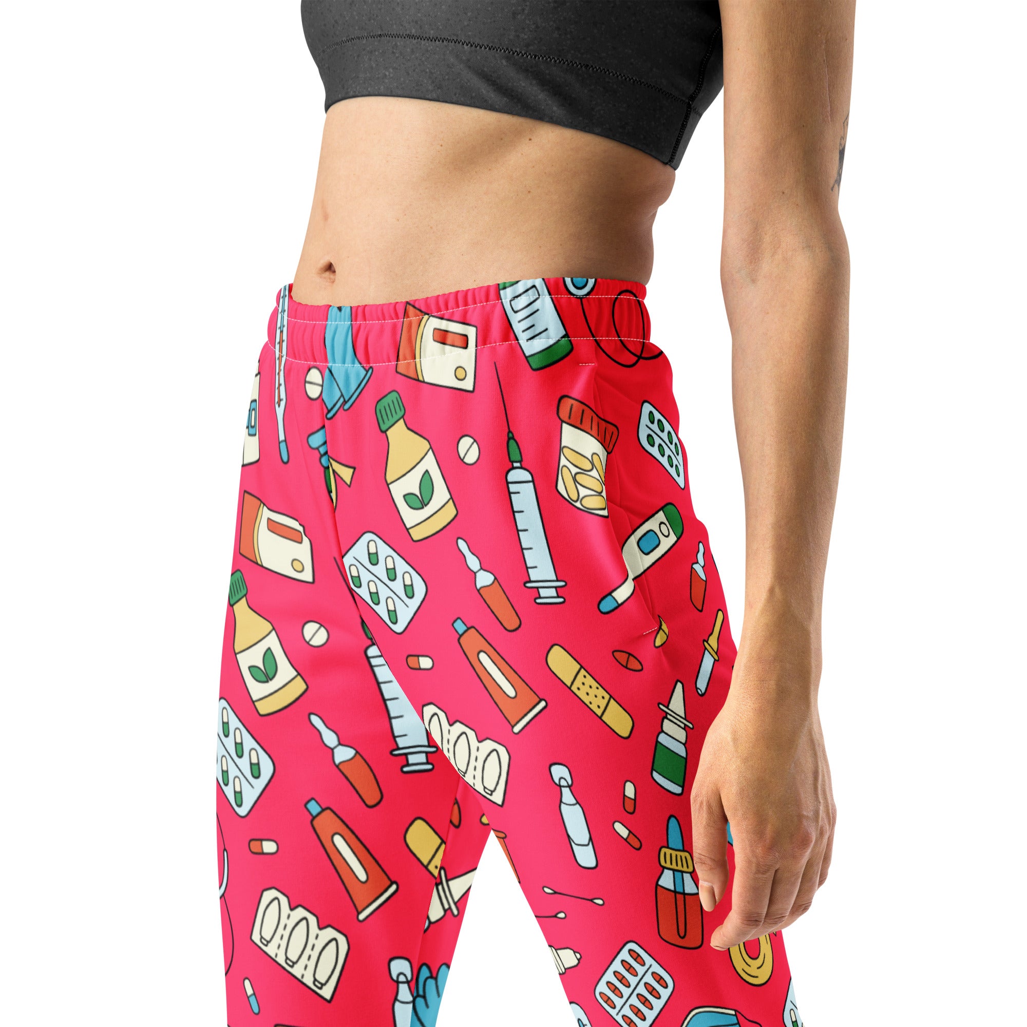 Women’s bright pink recycled jogger pants with cozy fleece inside and playful medical supplies print with pockets
