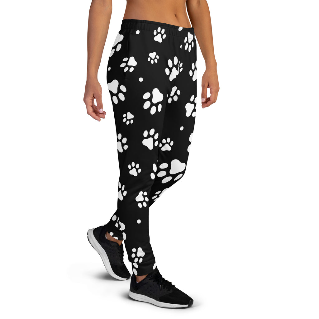 Black women’s jogger pants with white paw prints, cozy brushed inside fleece, recycled material, and pockets