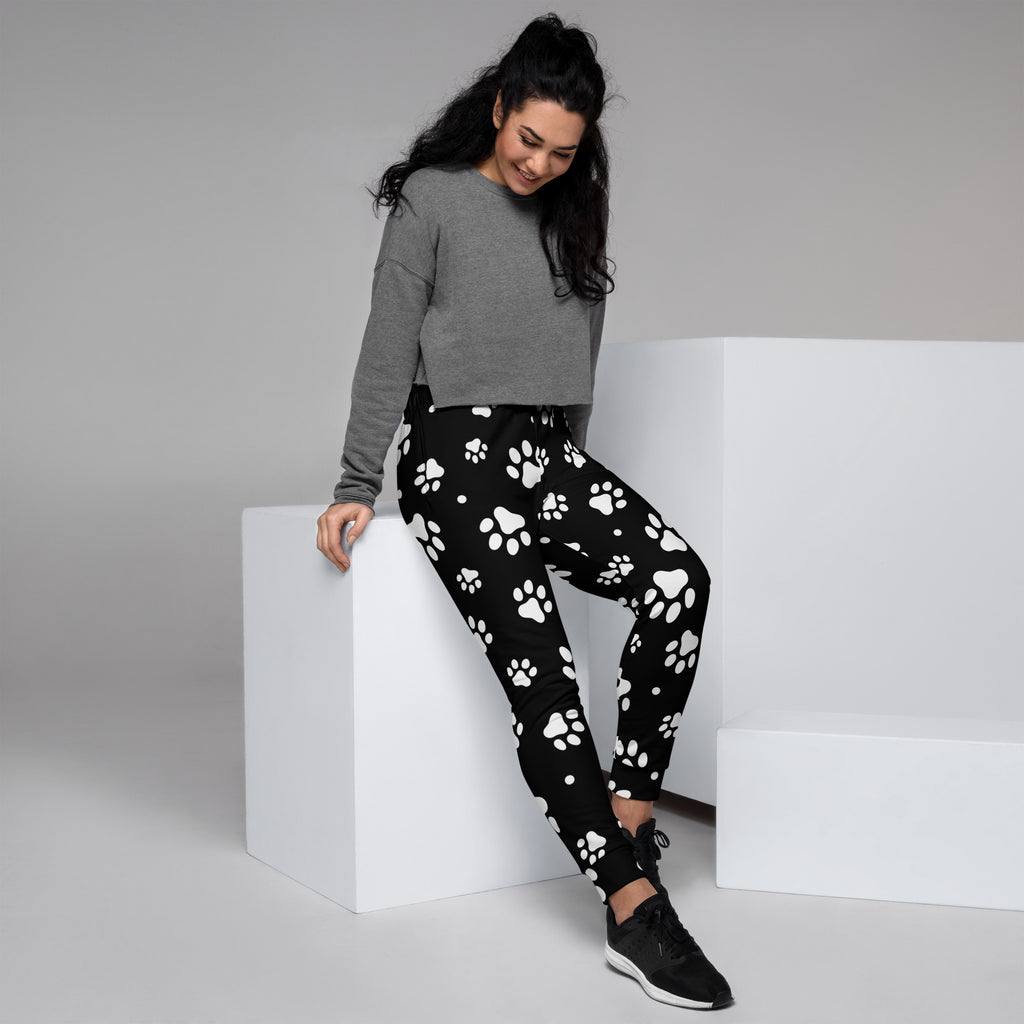 Women’s black recycled jogger pants with white paw print pattern cozy brushed fleece inside and pockets
