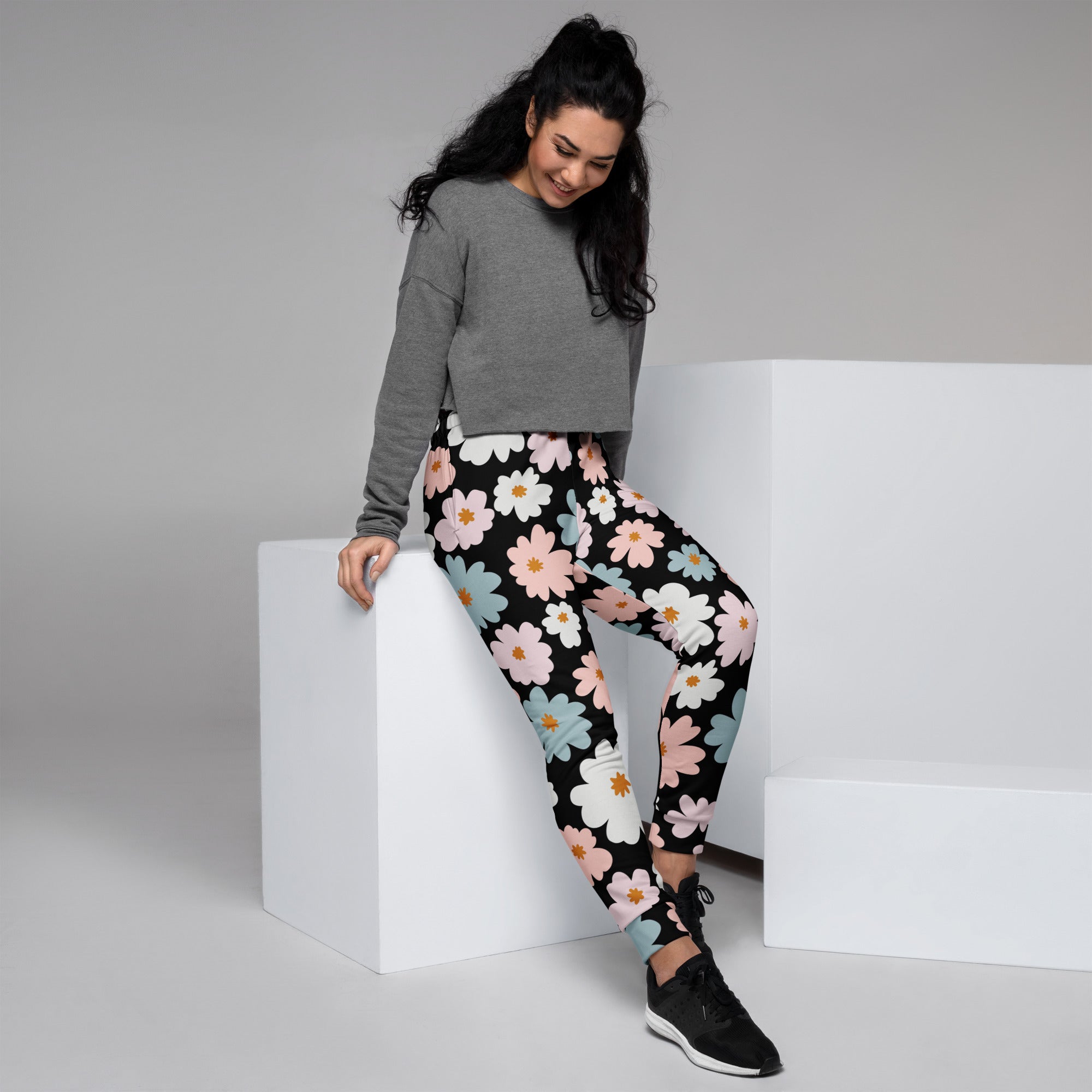 Women’s retro floral recycled jogger pants with pockets black leggings featuring vibrant white pink and light blue daisies