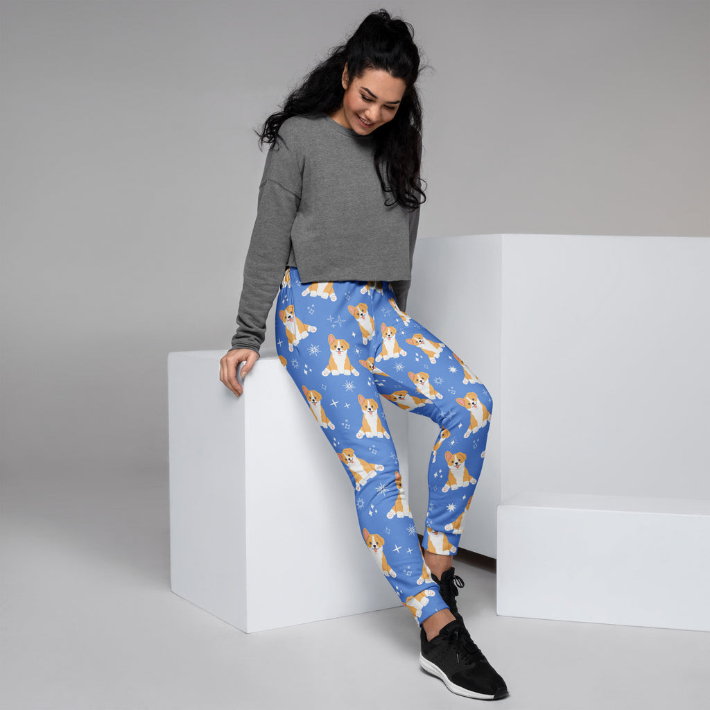 Women’s blue corgi dog recycled jogger pants with pockets featuring playful corgi and snowflake pattern and cozy fleece lining