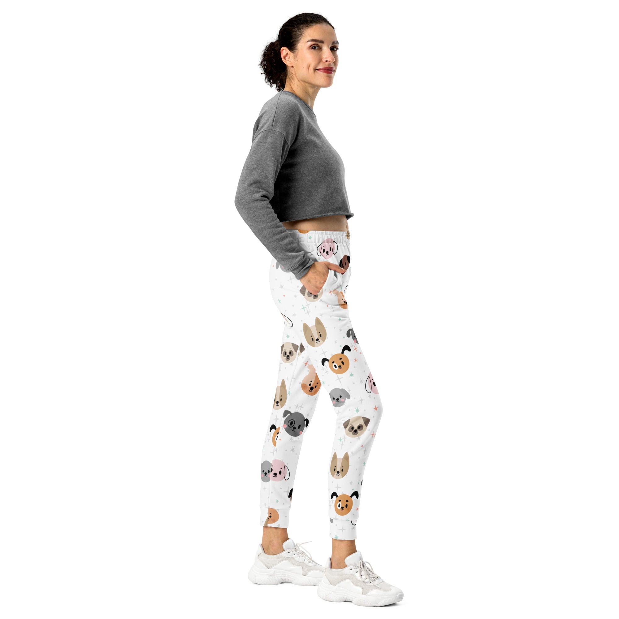 White women’s dog face recycled jogger pants with pockets featuring colorful cartoon dog patterns and cozy fleece inside