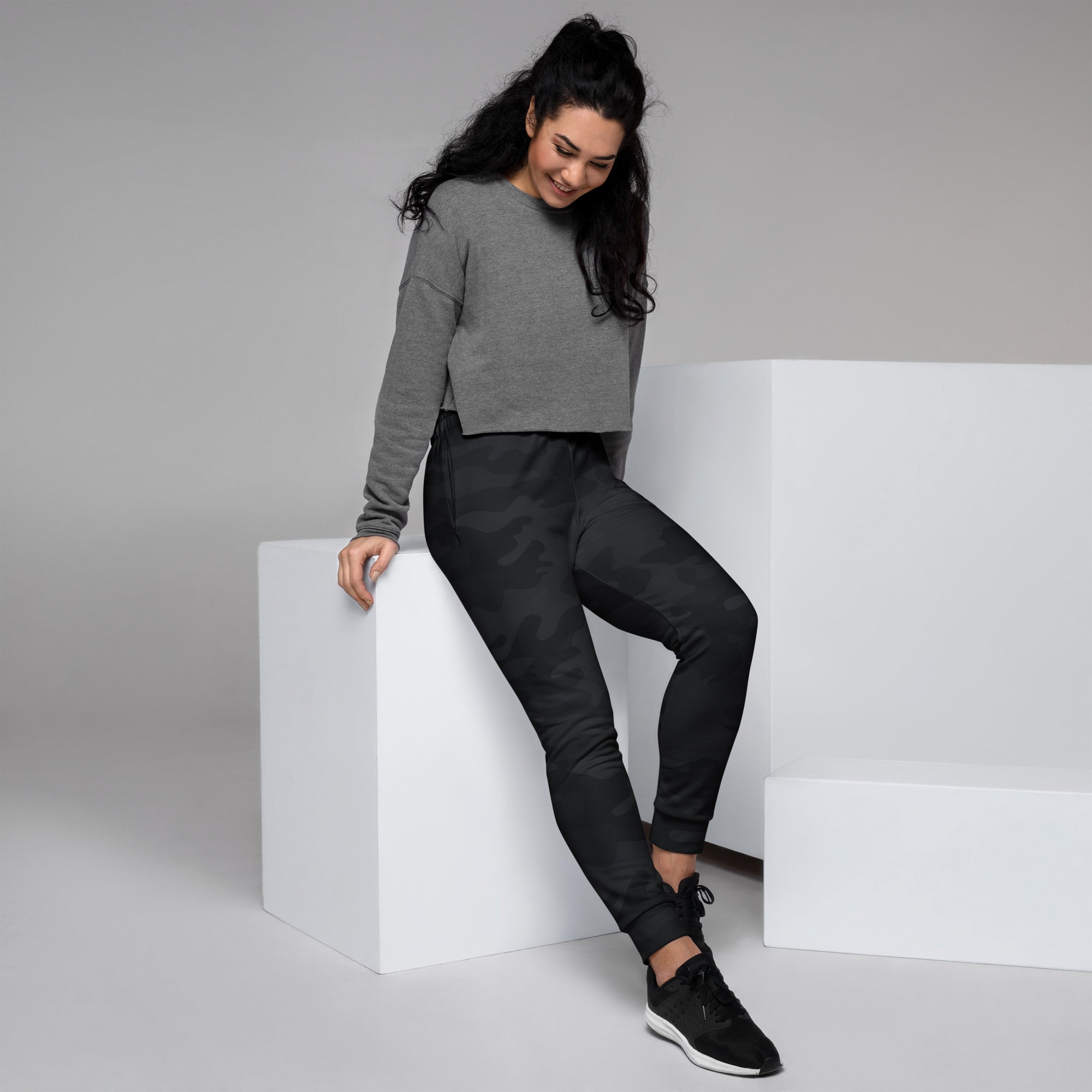 Women’s black camouflage recycled jogger pants with sleek fitted design elastic cuffs and cozy brushed fleece inside