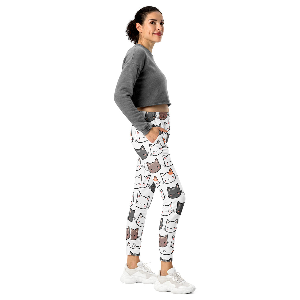Women’s white recycled jogger pants with cozy brushed fleece featuring colorful cartoon cat faces and pockets
