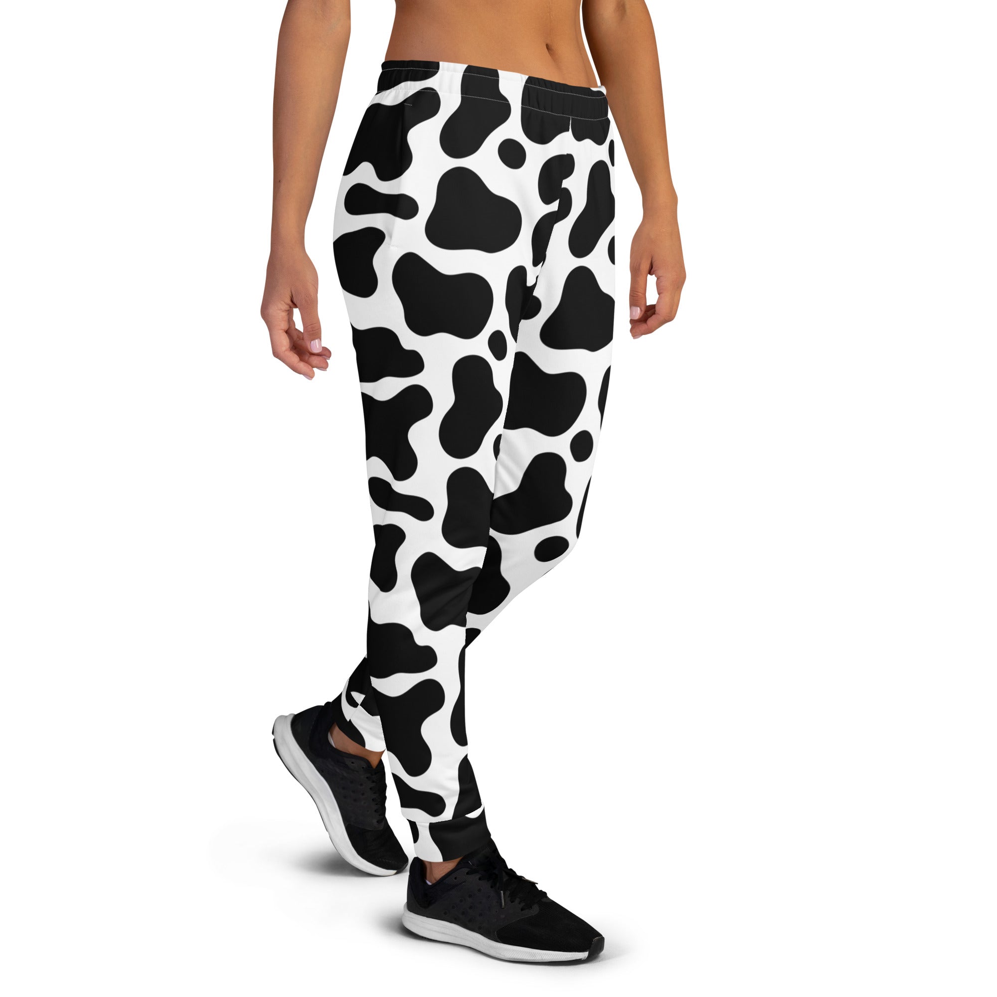 Women’s black and white cow print recycled jogger pants with pockets and cozy brushed inside fleece lining