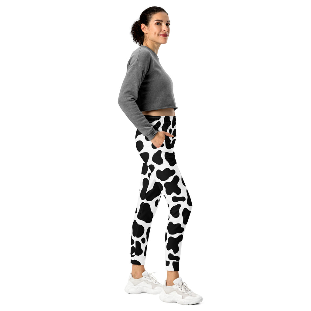 Women’s black and white cow print recycled jogger pants with pockets and cozy brushed inside fleece lining
