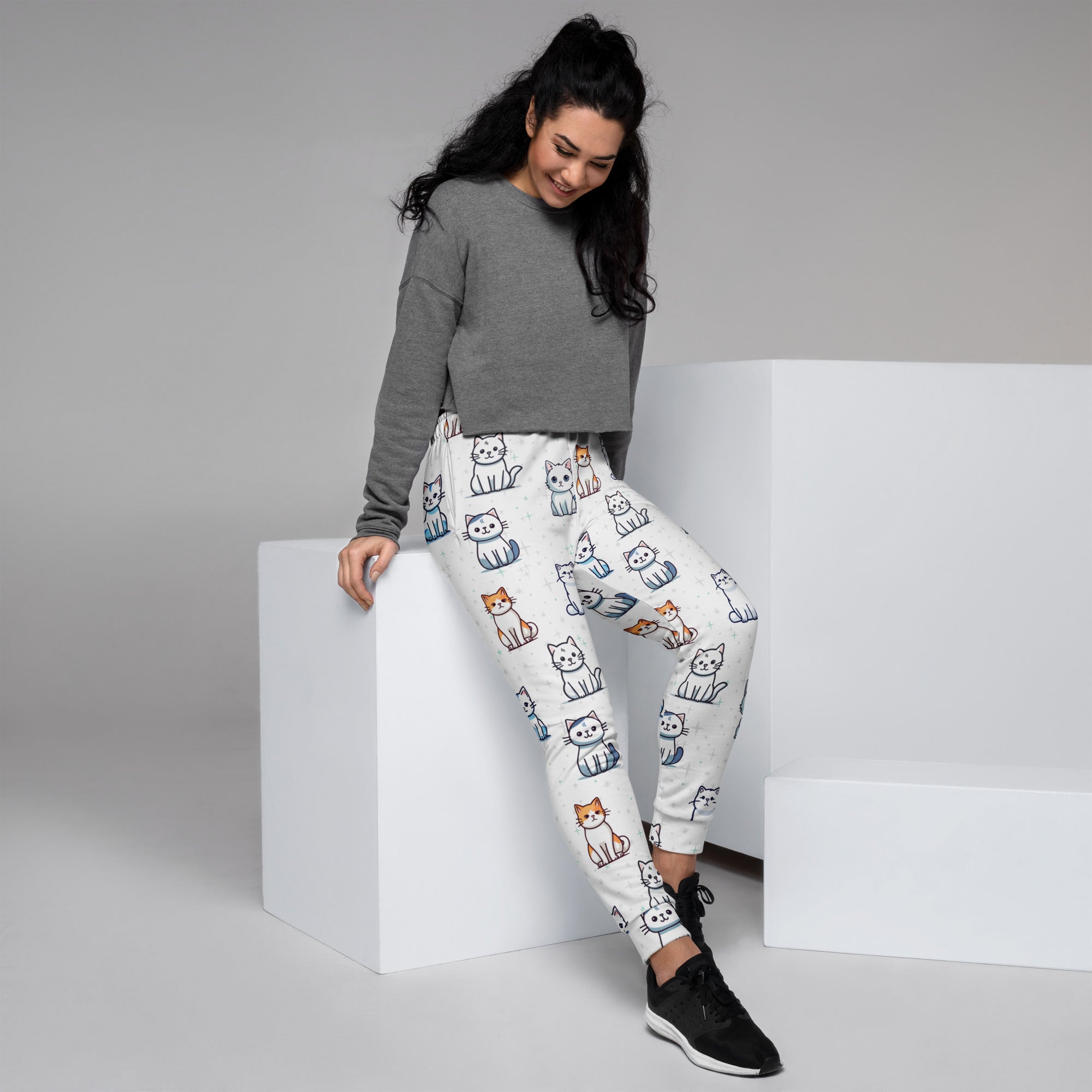 White women’s jogger pants with colorful cartoon cat pattern made of cozy recycled fleece with pockets