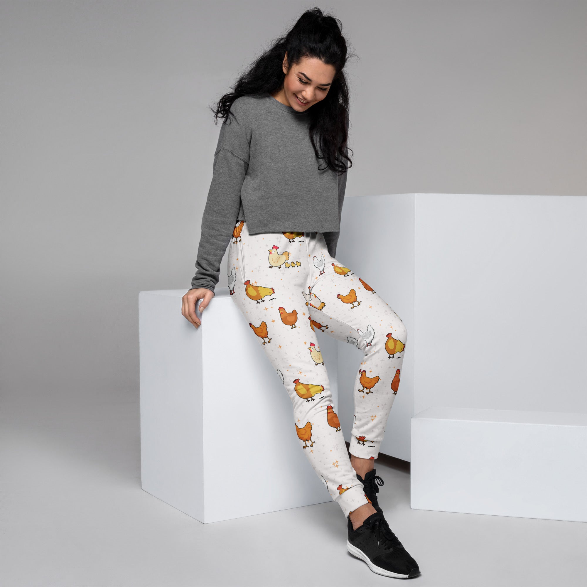 Women’s white chicken recycled jogger pants with cozy brushed fleece inside and playful orange brown chicken pattern