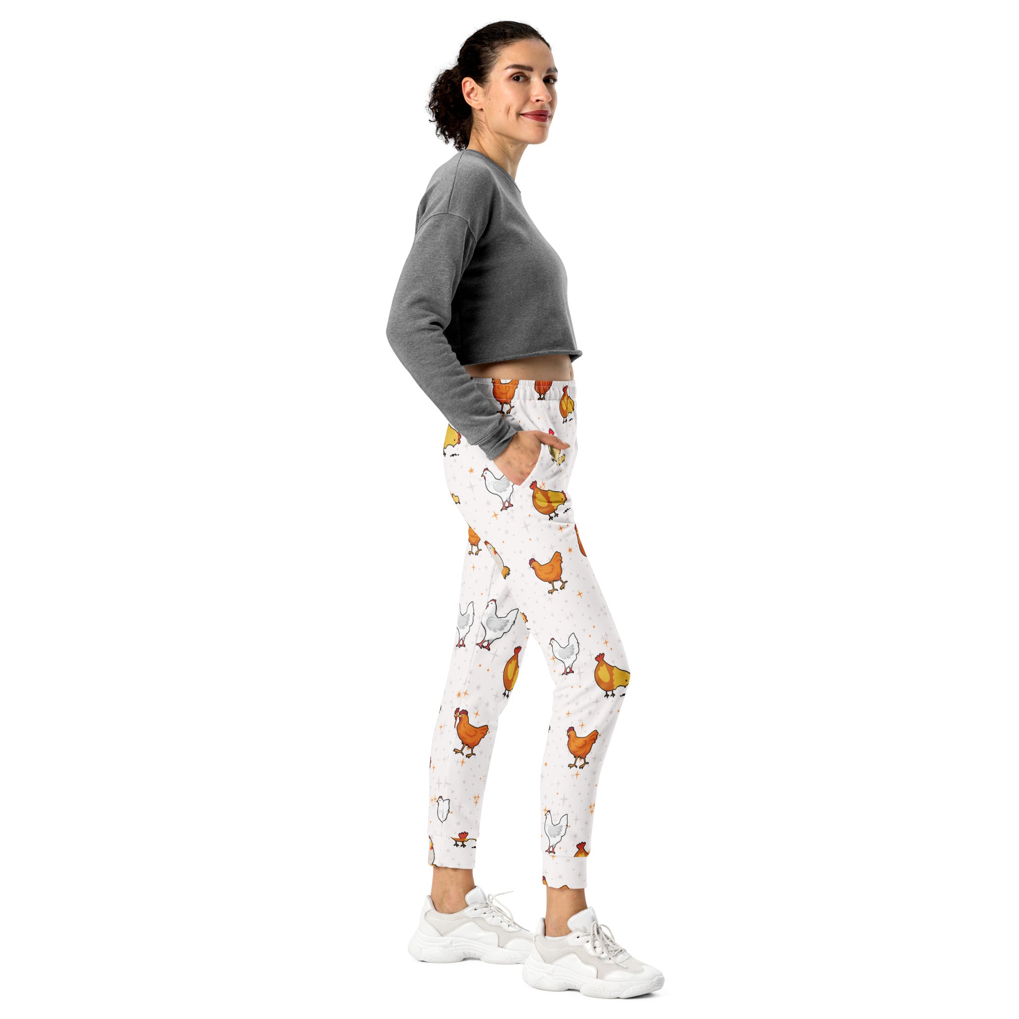White leggings with playful orange and white chicken pattern made from cozy recycled fleece jogger fabric with pockets