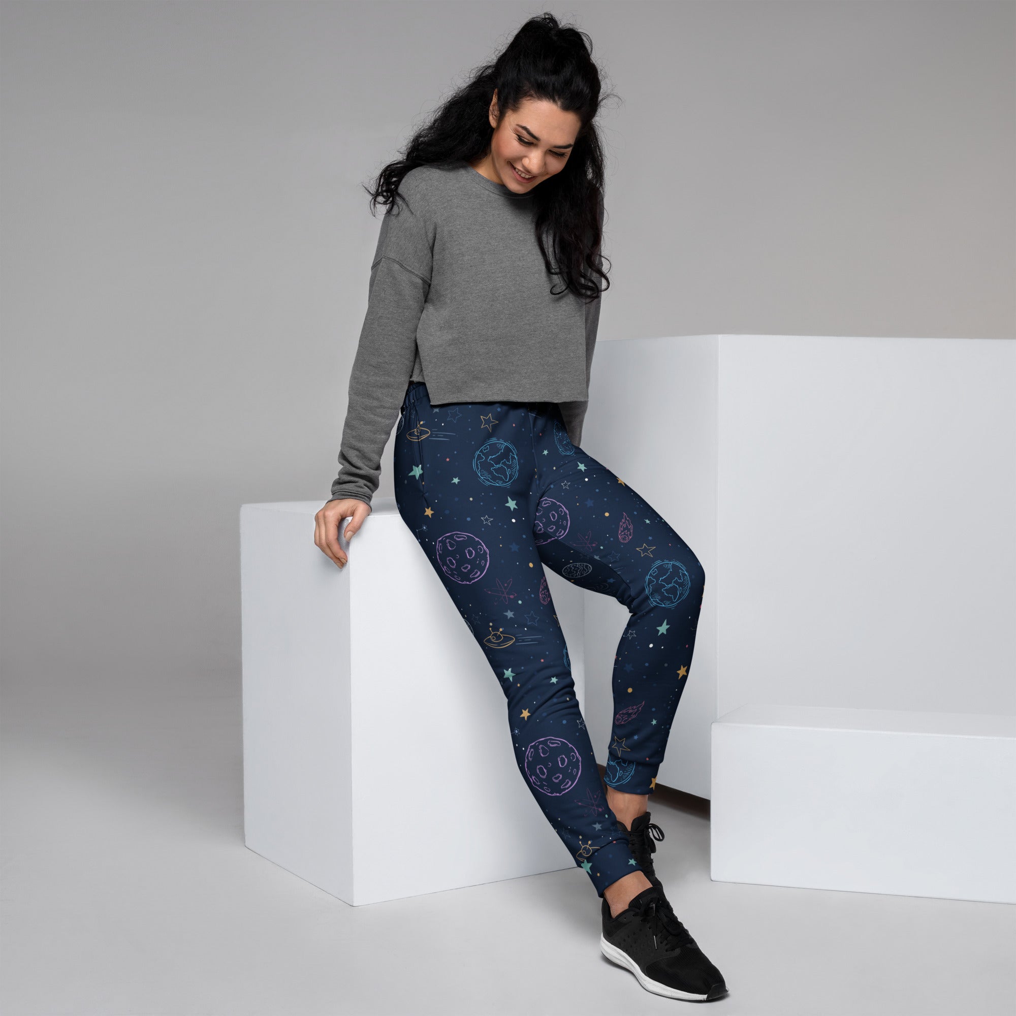 Women’s dark blue space-themed recycled jogger pants with celestial designs and cozy brushed inside fleece lining